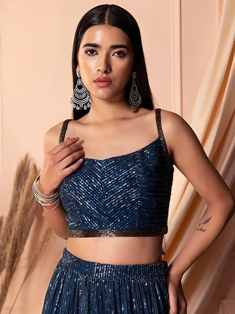 Sparkling navy blue sequin lehenga choli with spaghetti straps, perfect for Indian ethnic wear events.