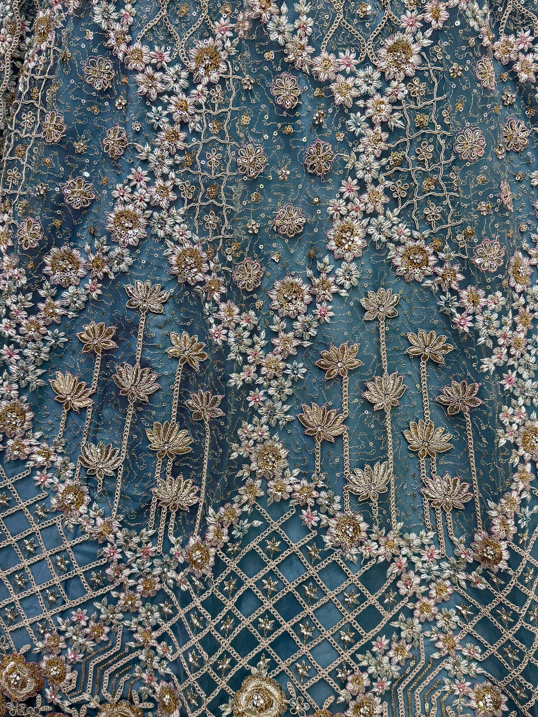Blue ethnic wear fabric with intricate gold and pink floral embroidery and sequin detailing