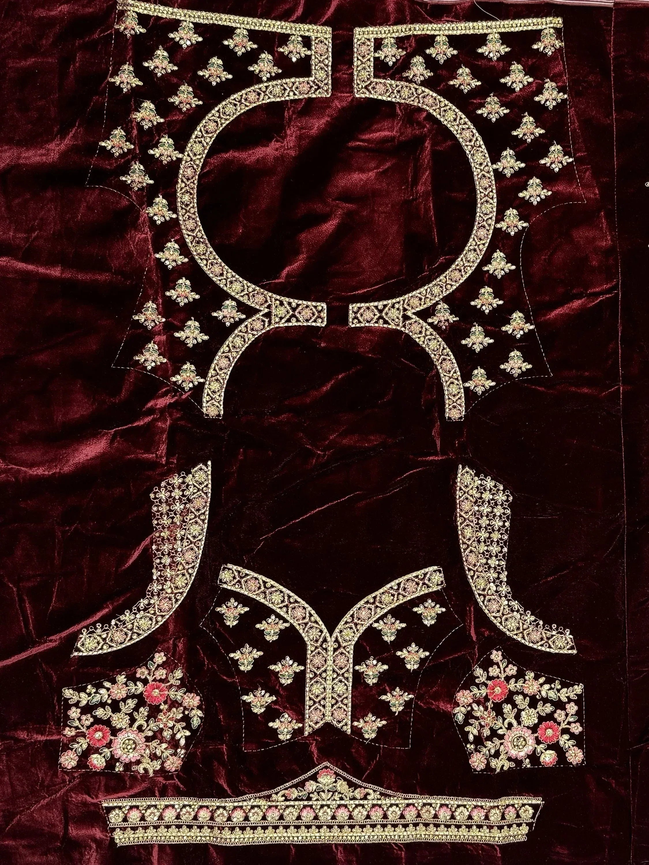 Maroon velvet ethnic wear with gold floral embroidery and intricate neckline design
