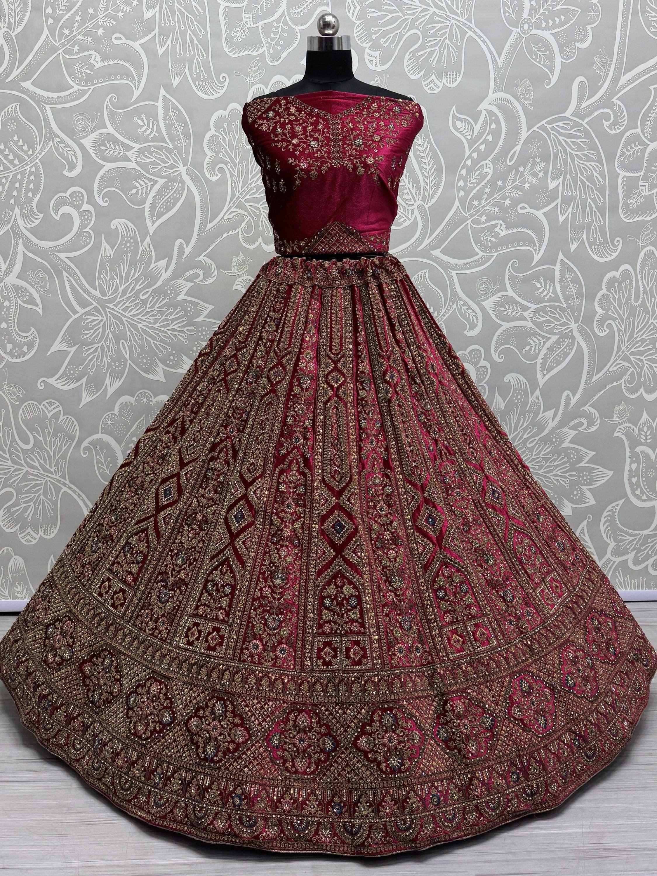 Maroon velvet designer lehenga choli with heavy gold embroidery, perfect for Indian weddings and festive occasions.