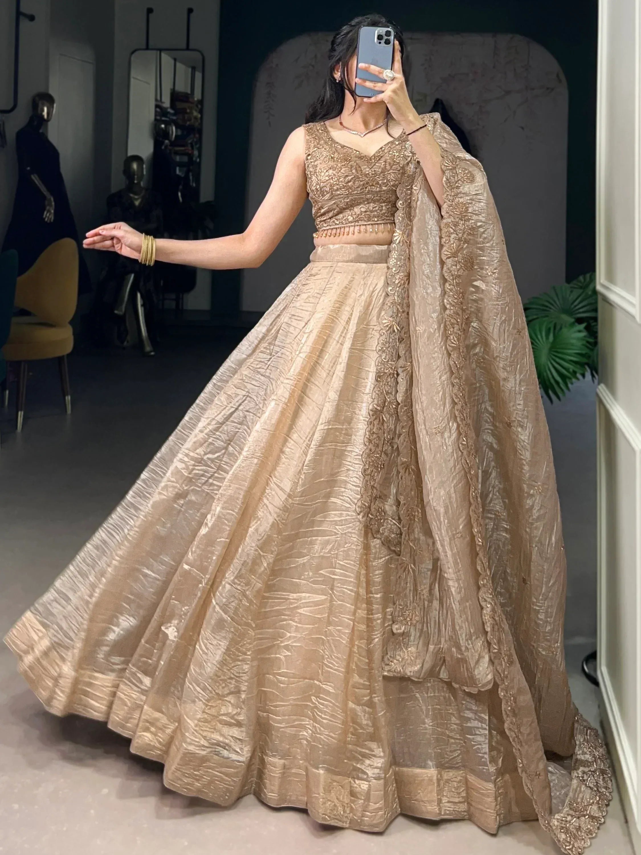 Elegant gold lehenga choli with intricate embroidery and flowing dupatta, perfect for Indian weddings and festive occasions.
