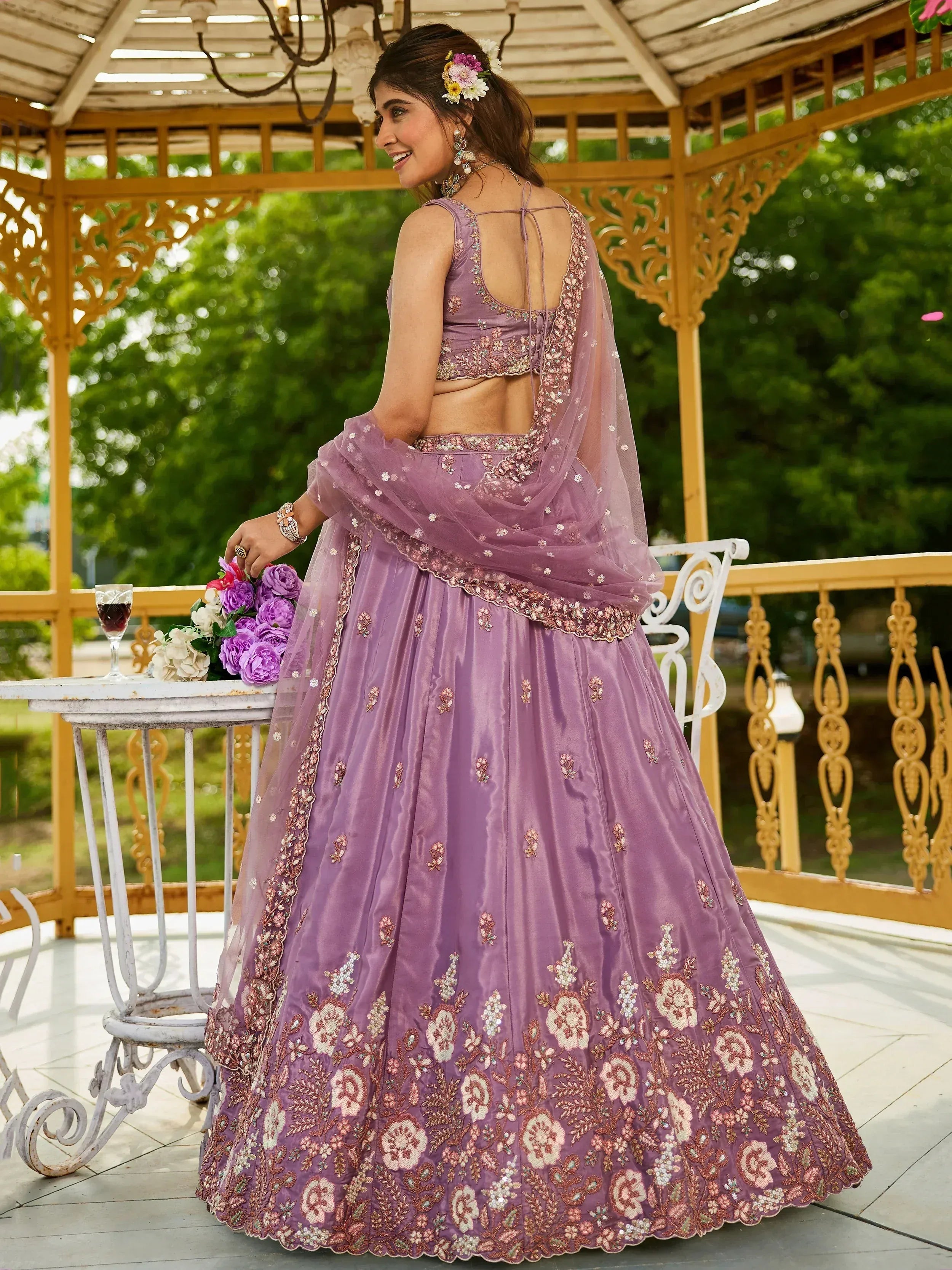 Purple floral embroidered lehenga choli with sheer dupatta, perfect for Indian weddings and festive occasions.