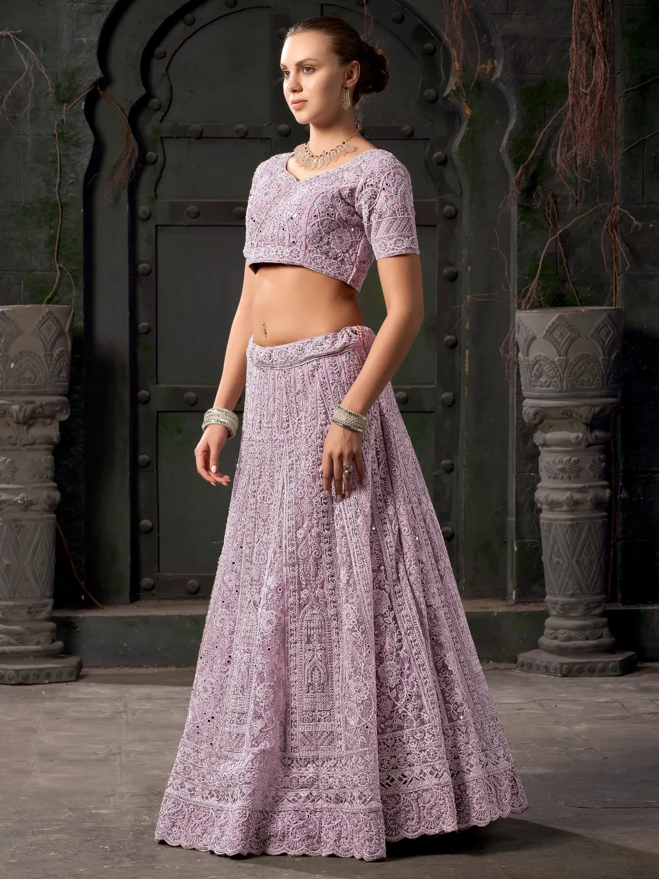 Lavender embroidered lehenga choli with intricate lace detailing, perfect for Indian ethnic wear occasions.