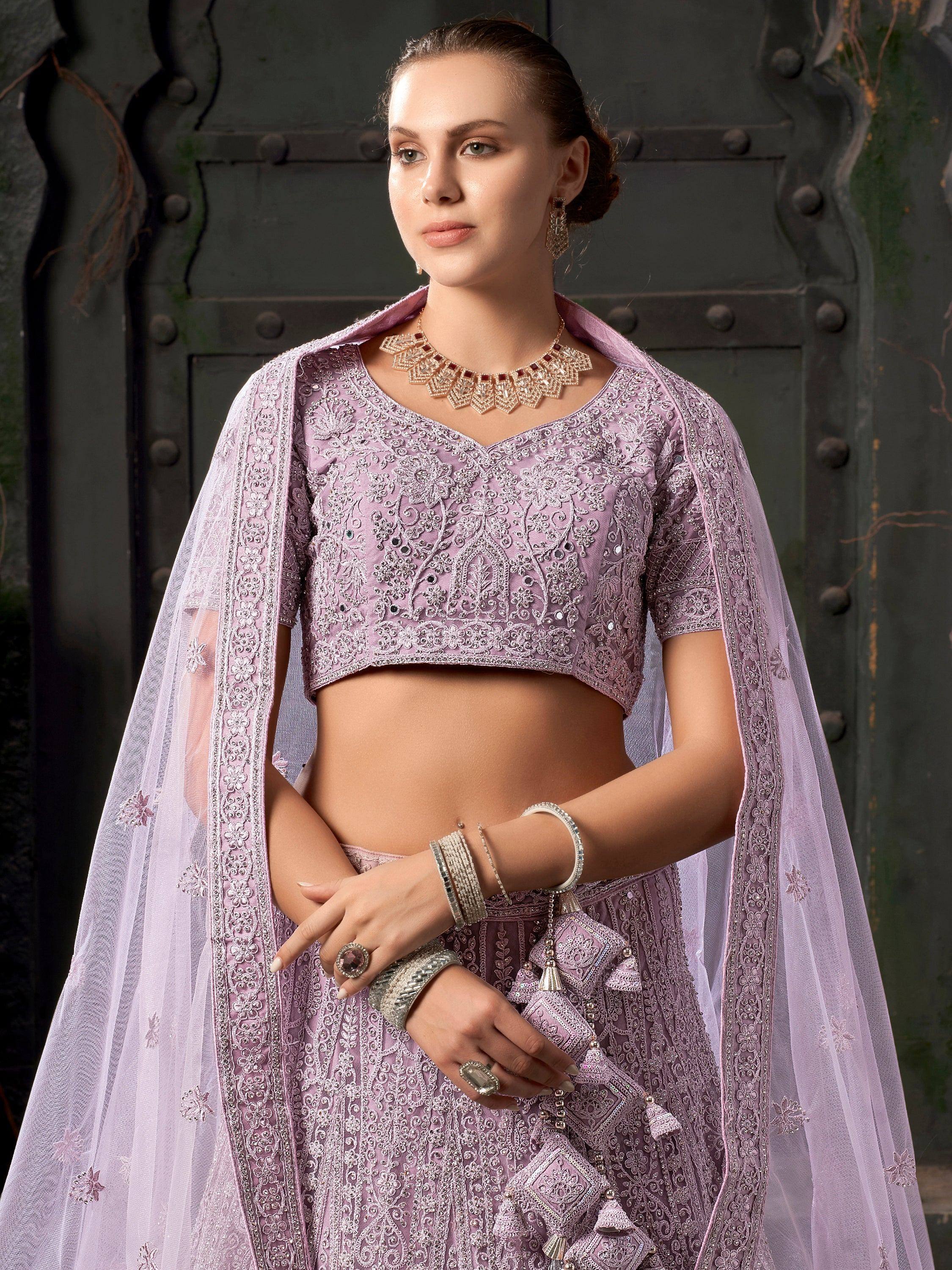 Lavender designer lehenga choli with intricate embroidery and sheer dupatta, perfect for Indian ethnic occasions.