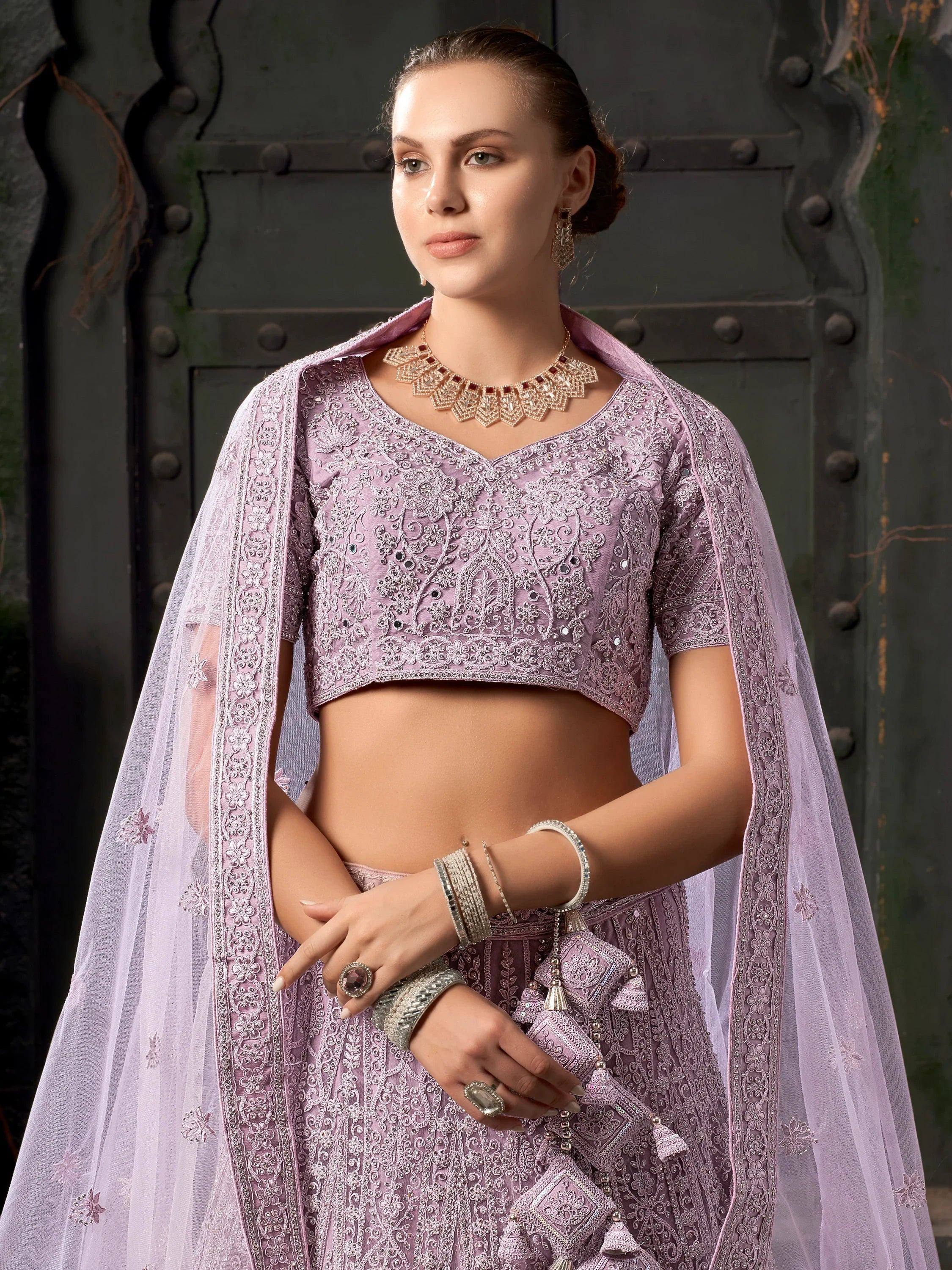 Lavender designer lehenga choli with intricate embroidery and sheer dupatta, perfect for Indian ethnic occasions