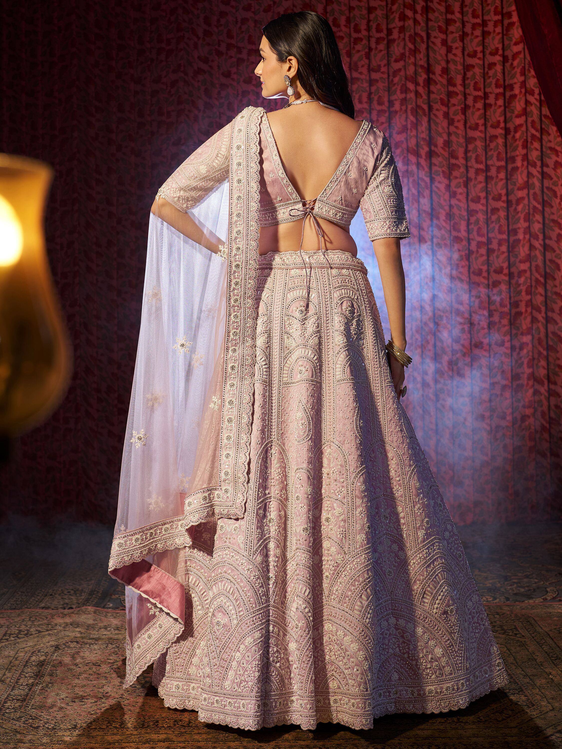 Elegant pink embroidered lehenga choli with sheer dupatta, perfect for Indian weddings and festive occasions.