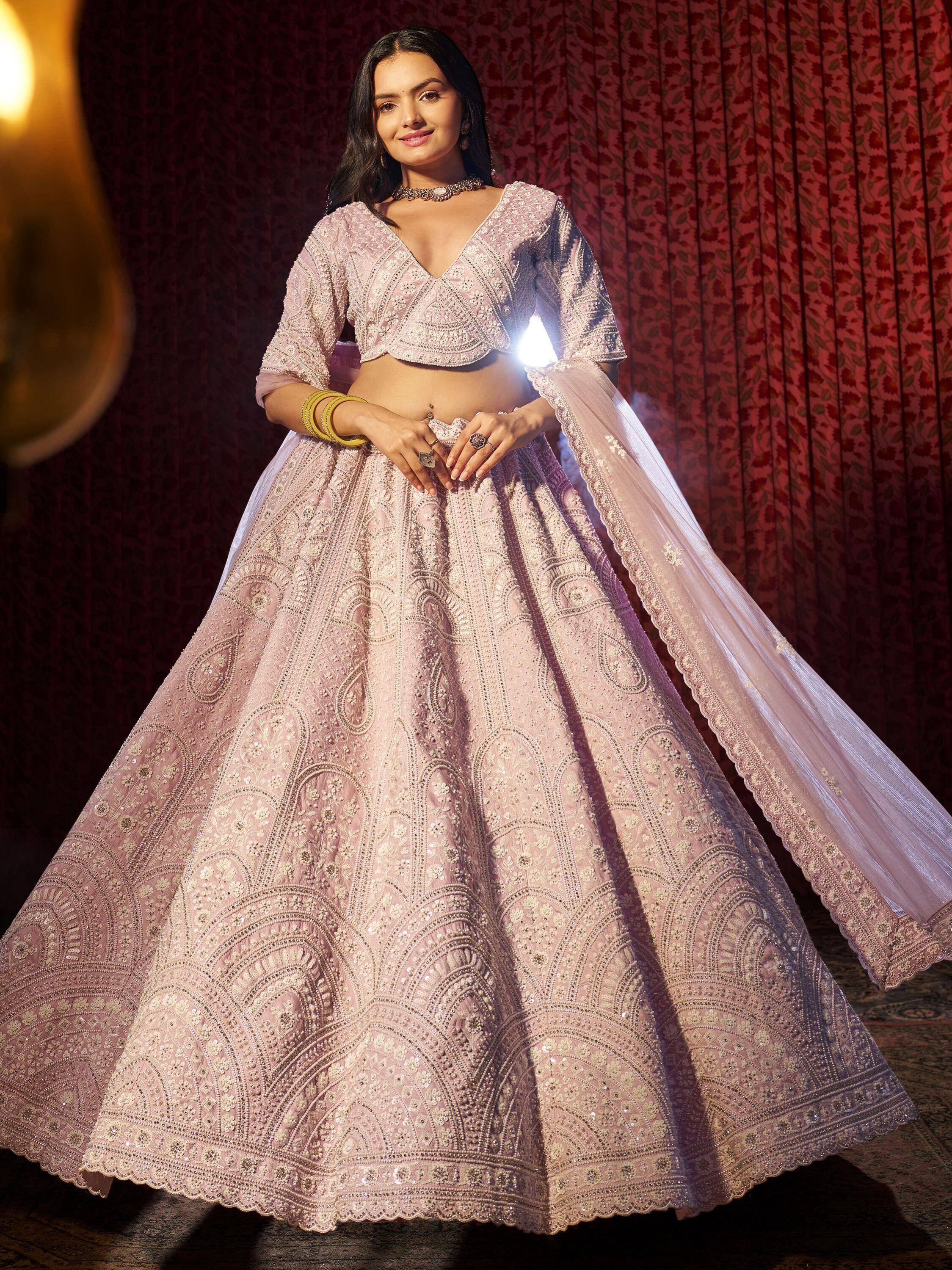 Elegant pink embroidered lehenga choli with dupatta, perfect for Indian weddings and festive occasions.