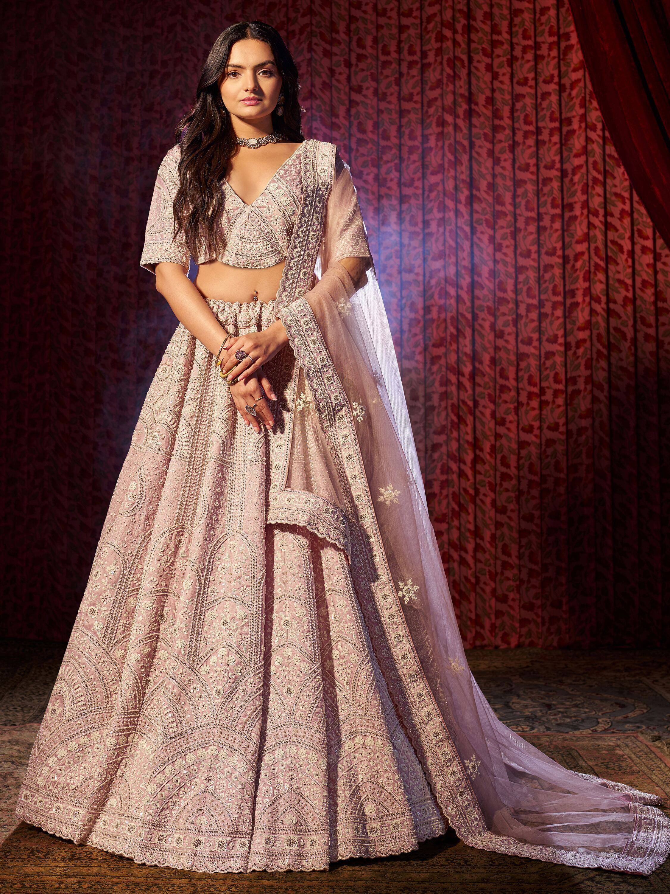 Elegant pink embroidered lehenga choli with sheer dupatta, perfect for Indian weddings and festive occasions.