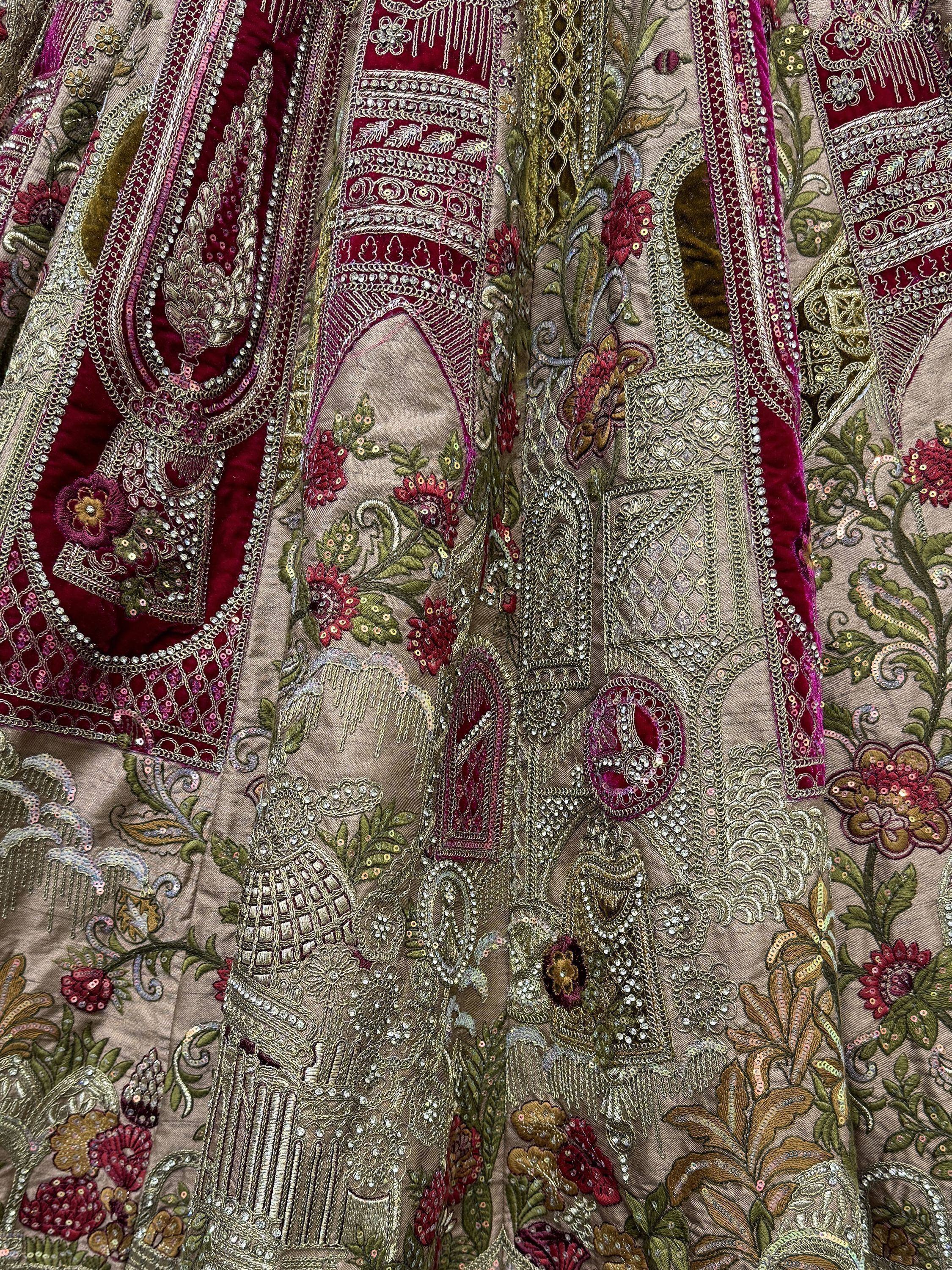 Luxury Indian ethnic wear with intricate floral embroidery, sequins, and velvet detailing in maroon and gold.
