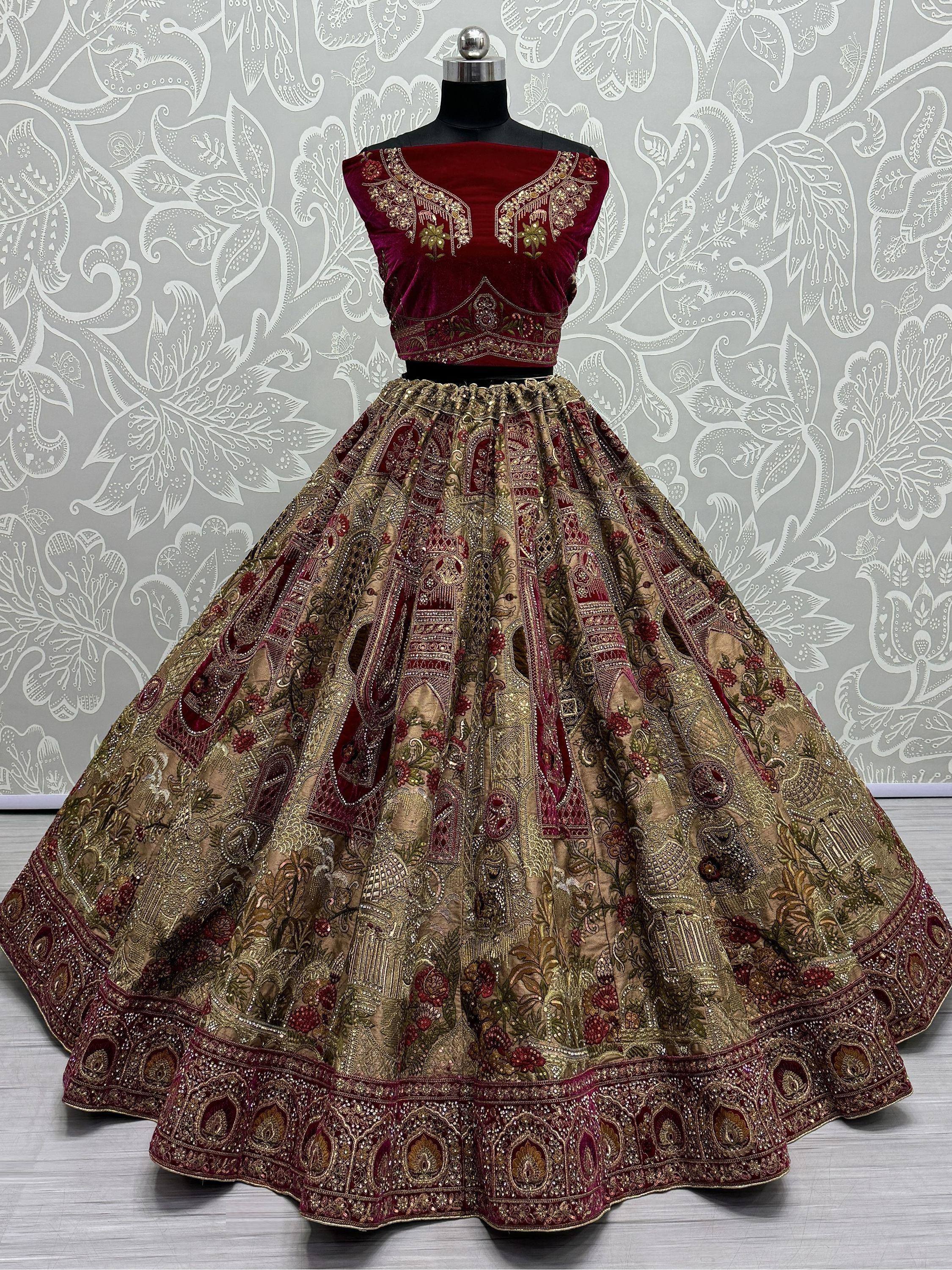 Maroon velvet designer lehenga choli with gold embroidery, perfect for Indian weddings and festive occasions.