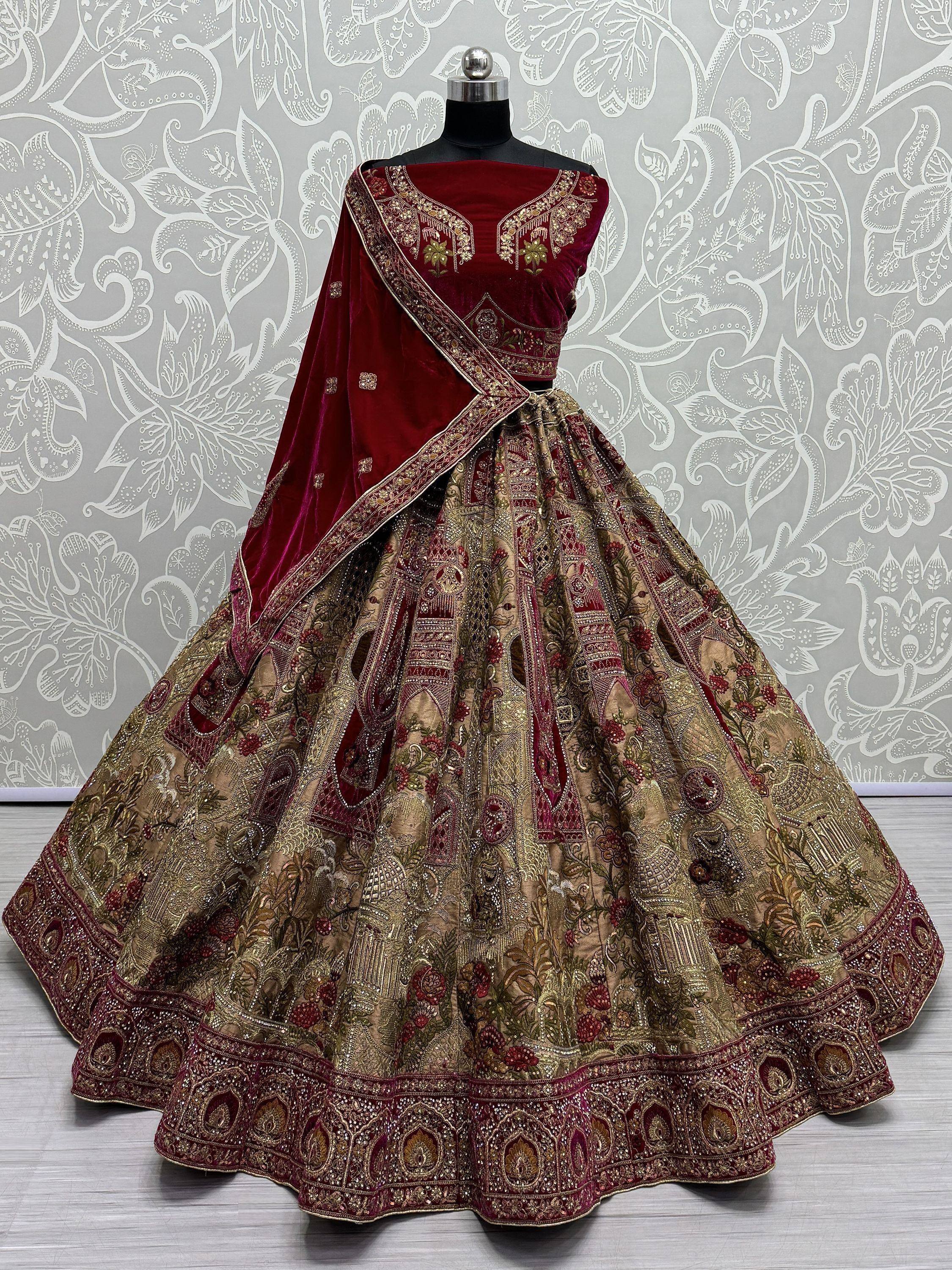 Maroon velvet designer lehenga choli with heavy gold embroidery and floral motifs, perfect for weddings