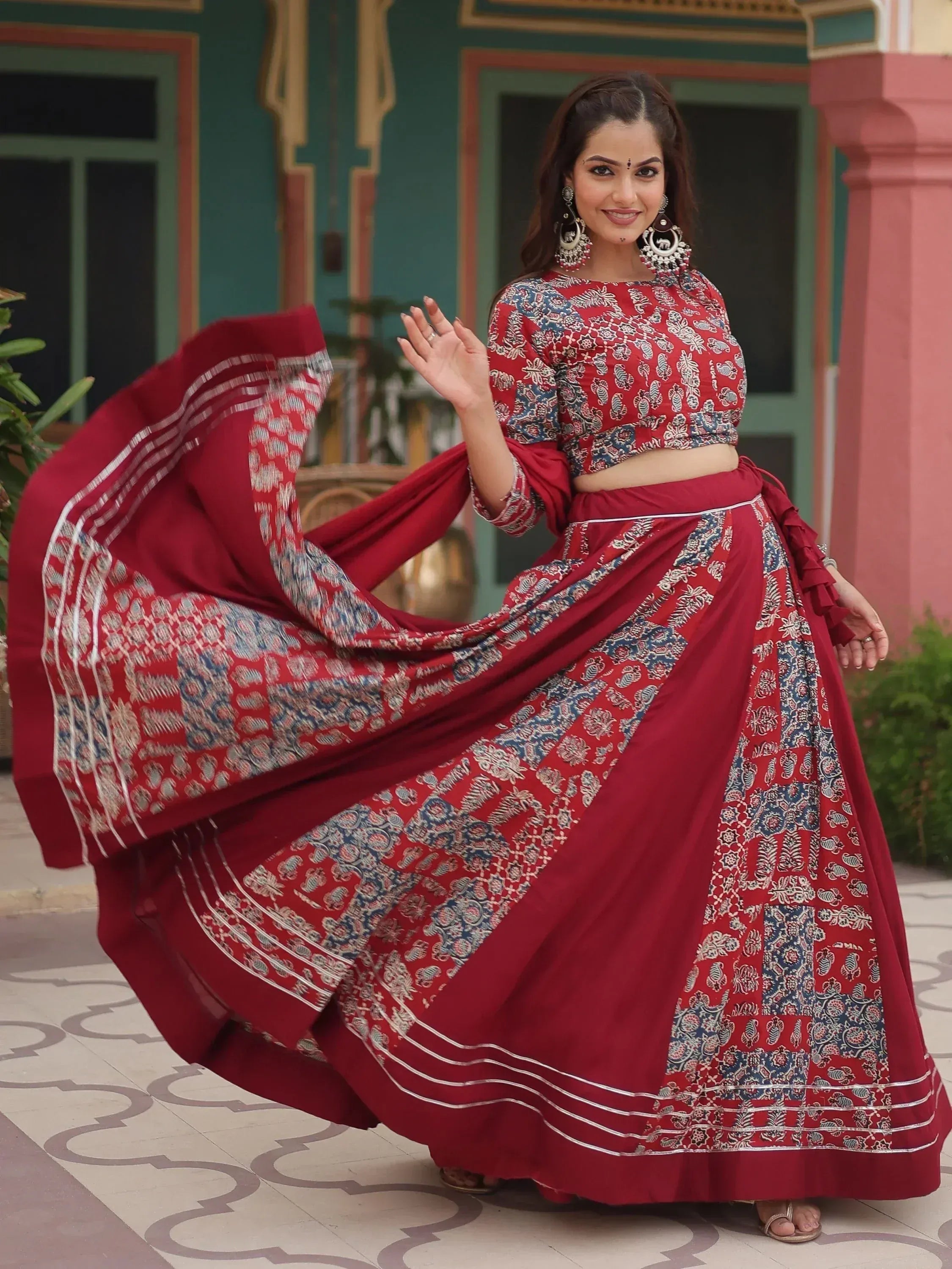 Red printed lehenga choli with blue floral motifs, perfect for Indian ethnic wear occasions