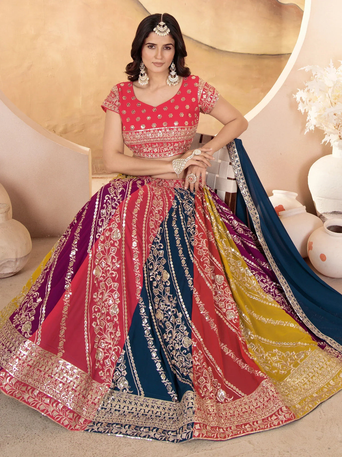 Woman in vibrant multicolor lehenga choli with gold embroidery, perfect for Indian ethnic wear occasions.