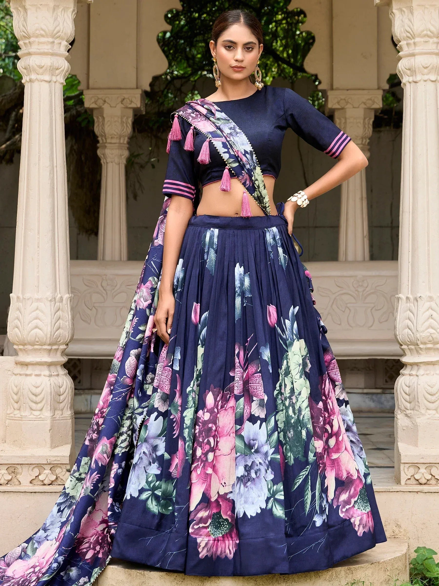 Navy blue floral lehenga choli with pink tassels, perfect for Indian ethnic wear occasions.