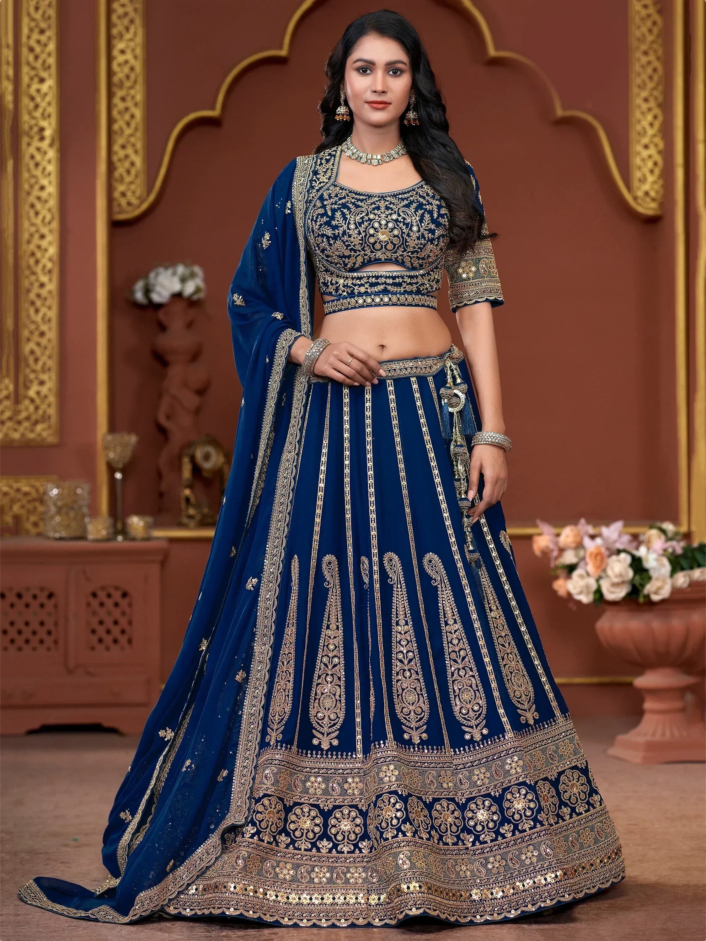 Royal blue designer lehenga choli with gold embroidery, perfect for weddings and festive occasions.