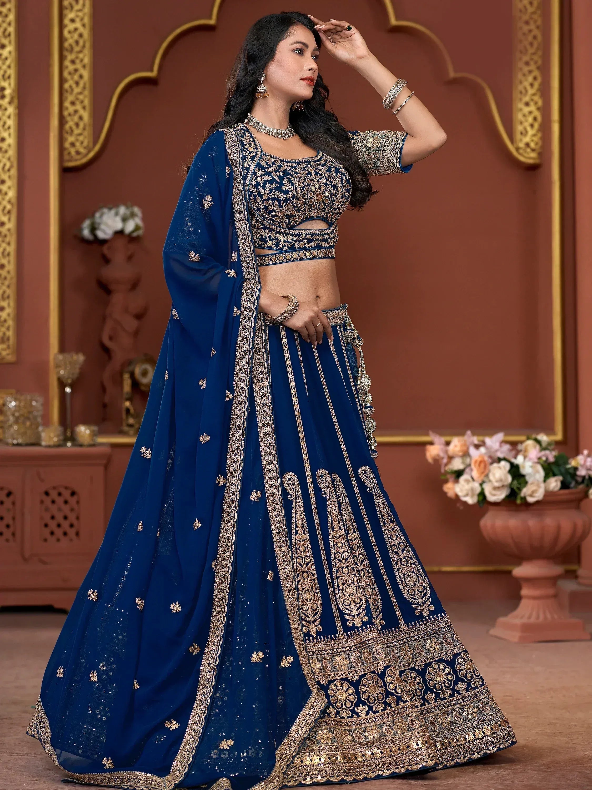 Royal blue designer lehenga choli with gold embroidery, perfect for Indian weddings and festive occasions.