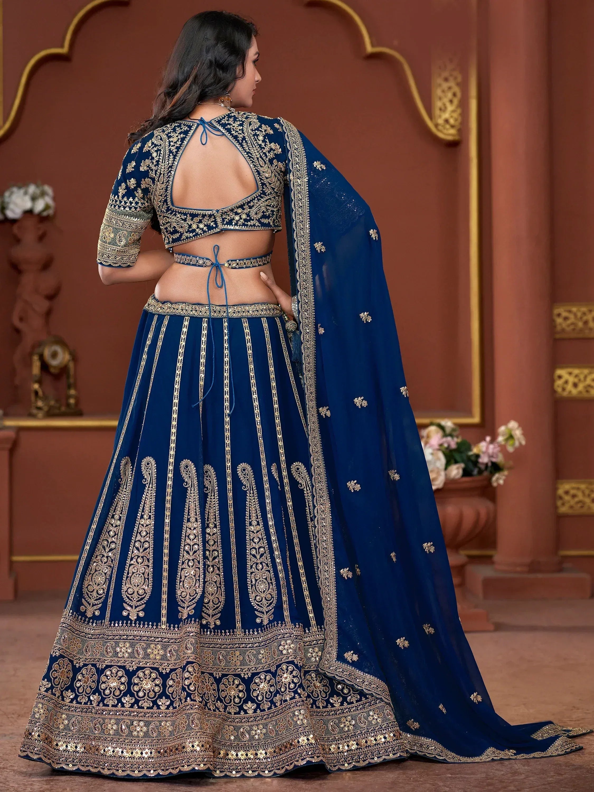 Blue designer lehenga choli with gold embroidery, back view, ethnic wear for weddings