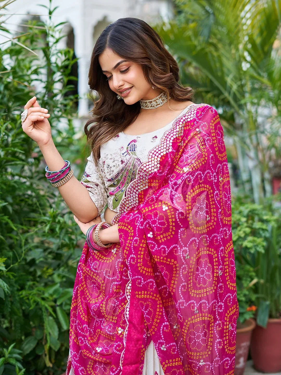 Woman in elegant Indian ethnic wear with peacock embroidery and pink dupatta, perfect for festive occasions