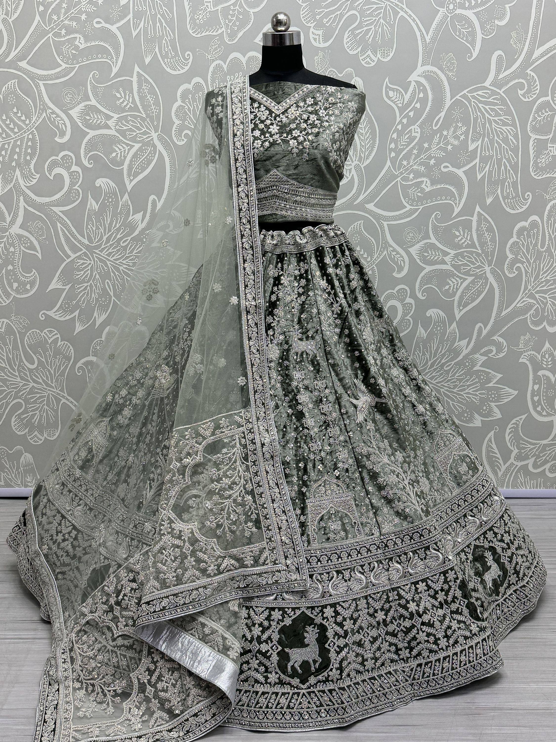 Elegant grey velvet lehenga choli with silver embroidery and sheer dupatta, perfect for Indian weddings and festive occasions.