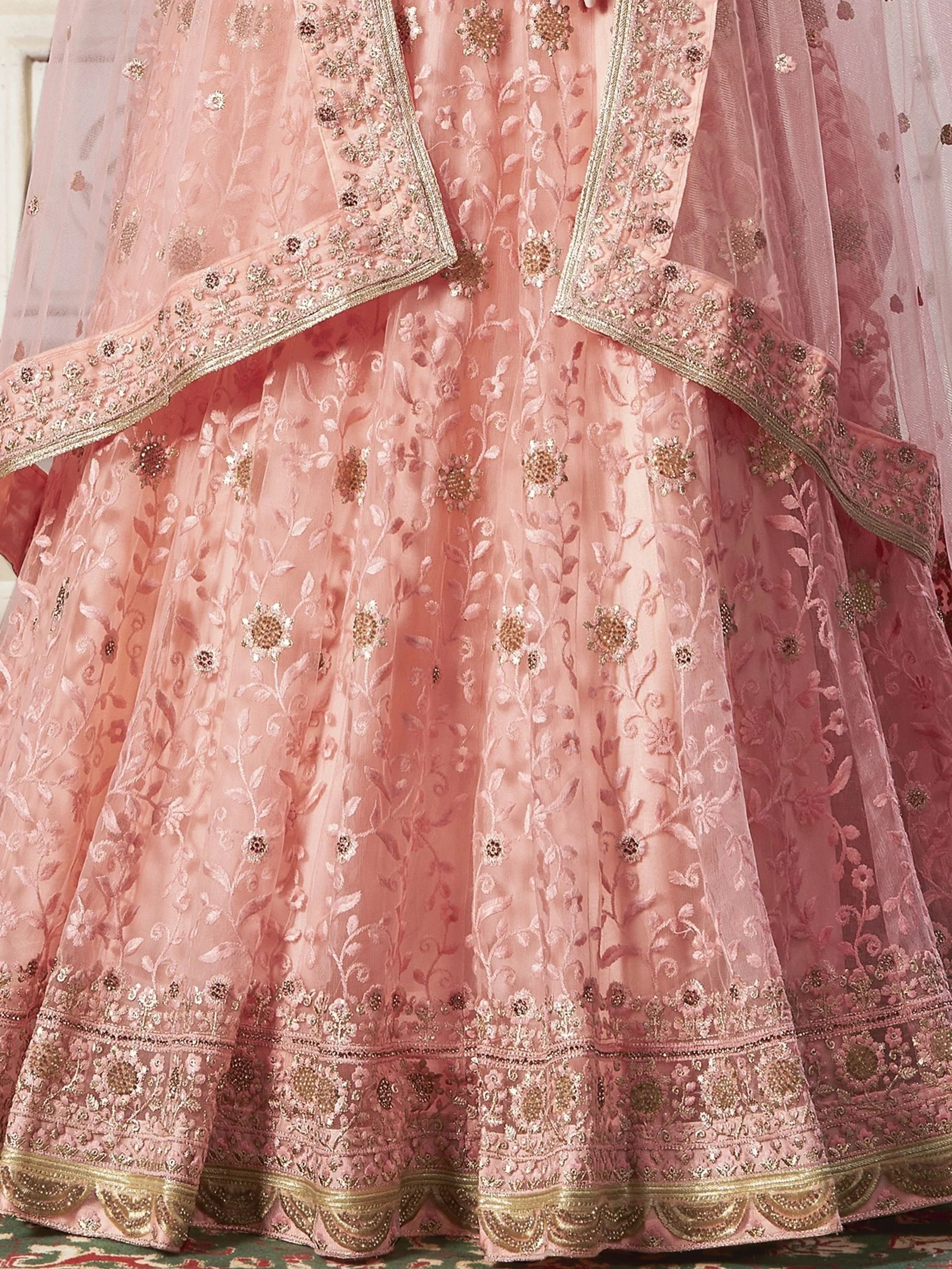 Pink embroidered lehenga choli with floral zari work, perfect for Indian weddings and festive occasions.