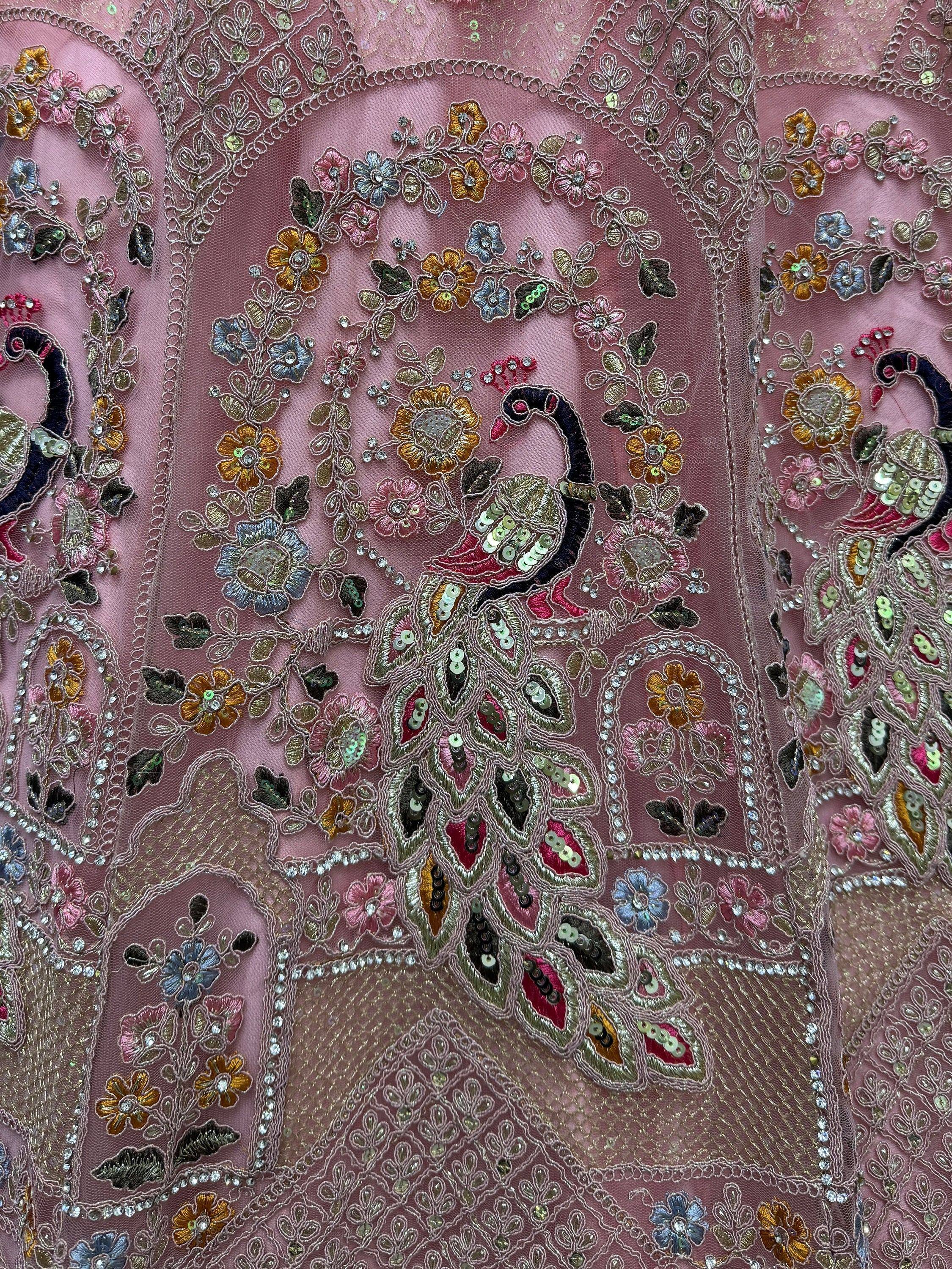 Pink ethnic gown with peacock embroidery, floral sequins, and intricate threadwork for festive occasions