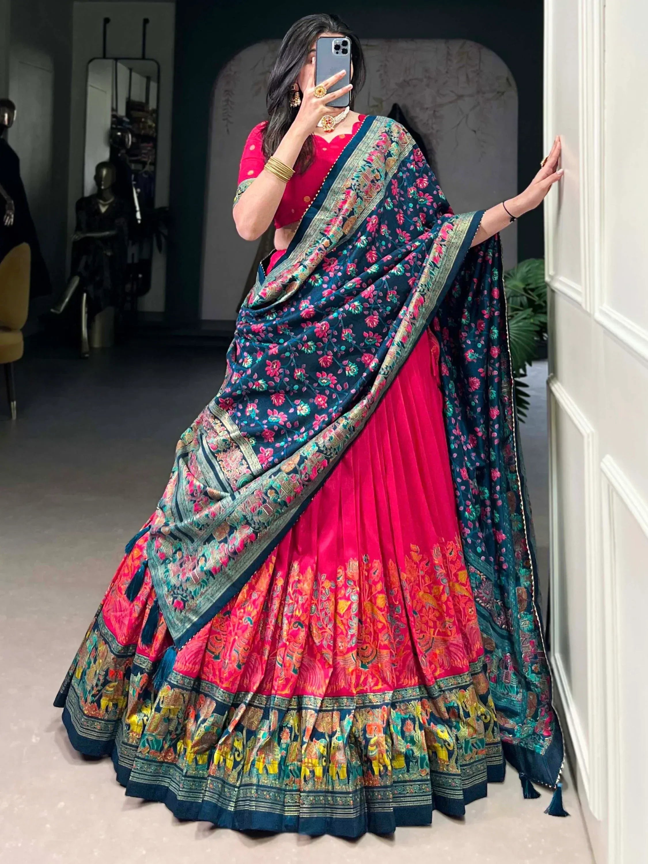 Woman in vibrant pink lehenga choli with floral navy dupatta, Indian ethnic wear