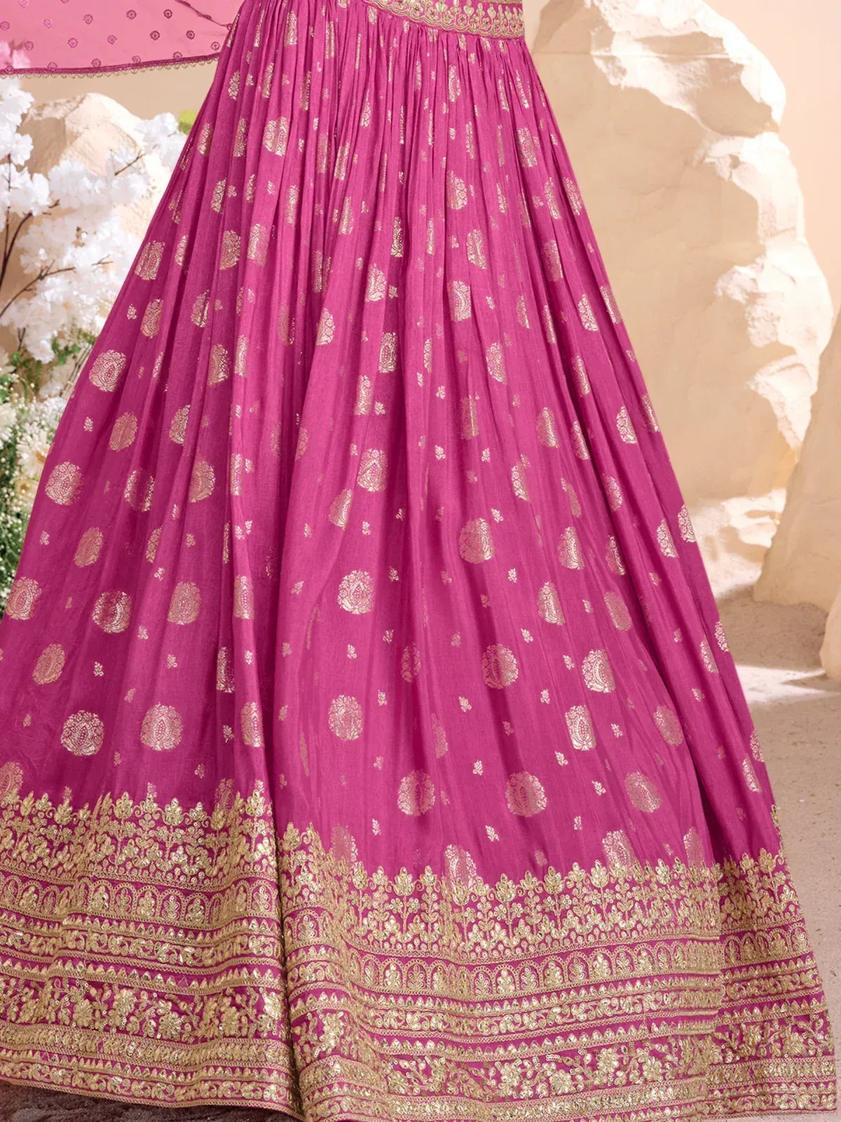 Pink designer lehenga with gold paisley print and intricate border, perfect for Indian ethnic wear