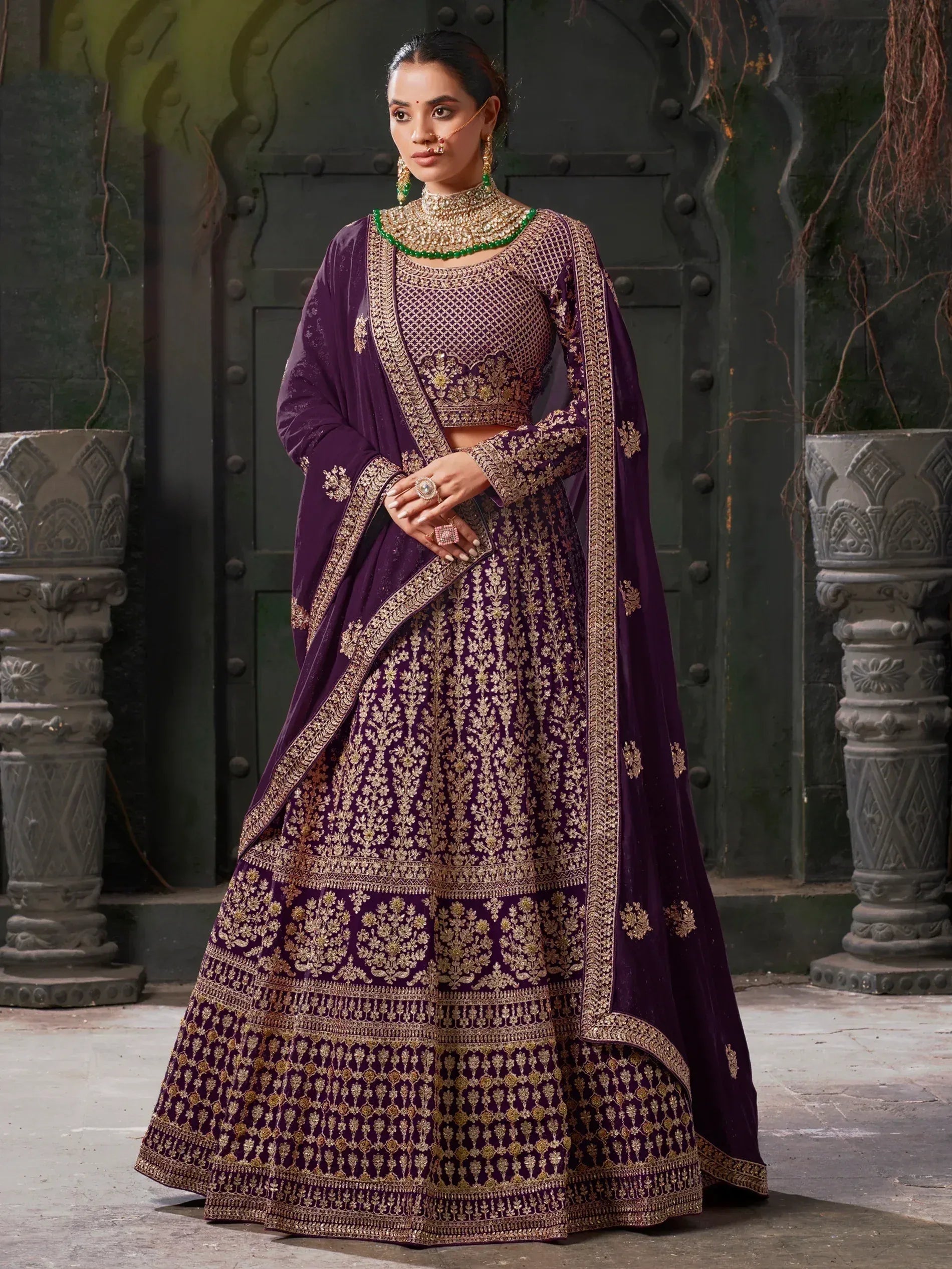 Purple designer lehenga choli with gold embroidery, perfect for Indian weddings and festive occasions.