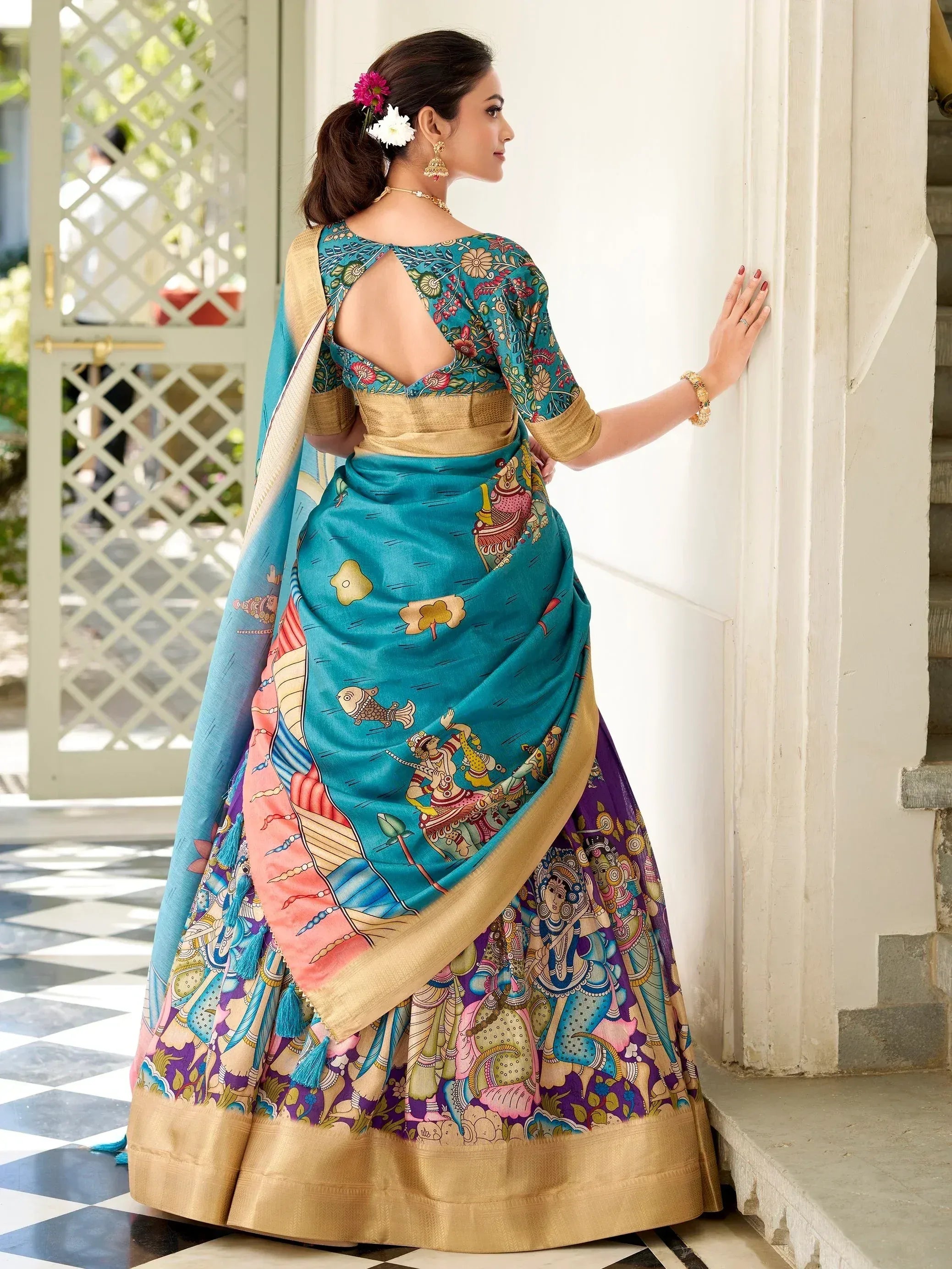 Teal printed lehenga choli with gold border, floral back design, and traditional Indian motifs for festive occasions