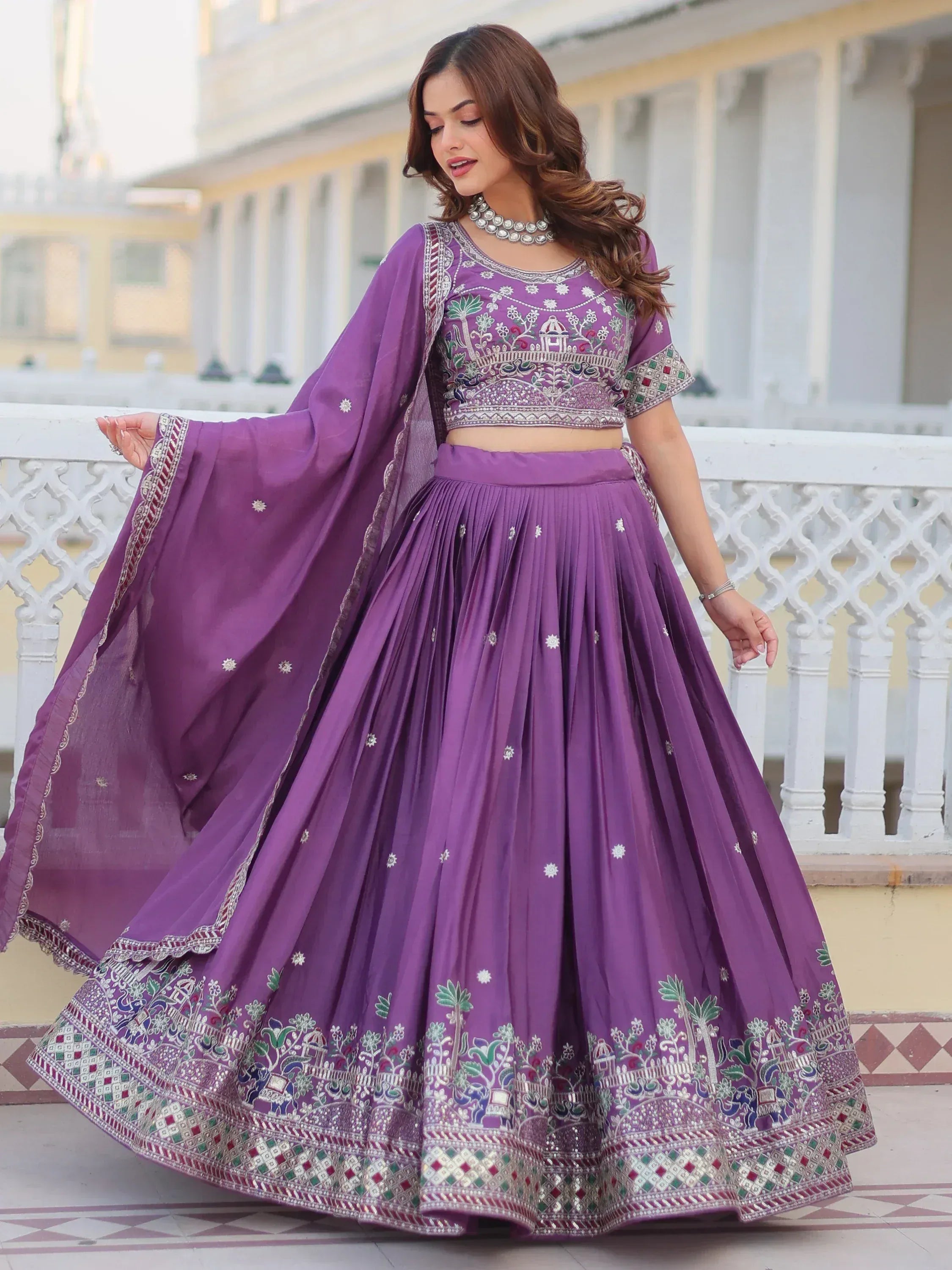 Purple embroidered lehenga choli with floral and elephant motifs, perfect for Indian ethnic occasions.