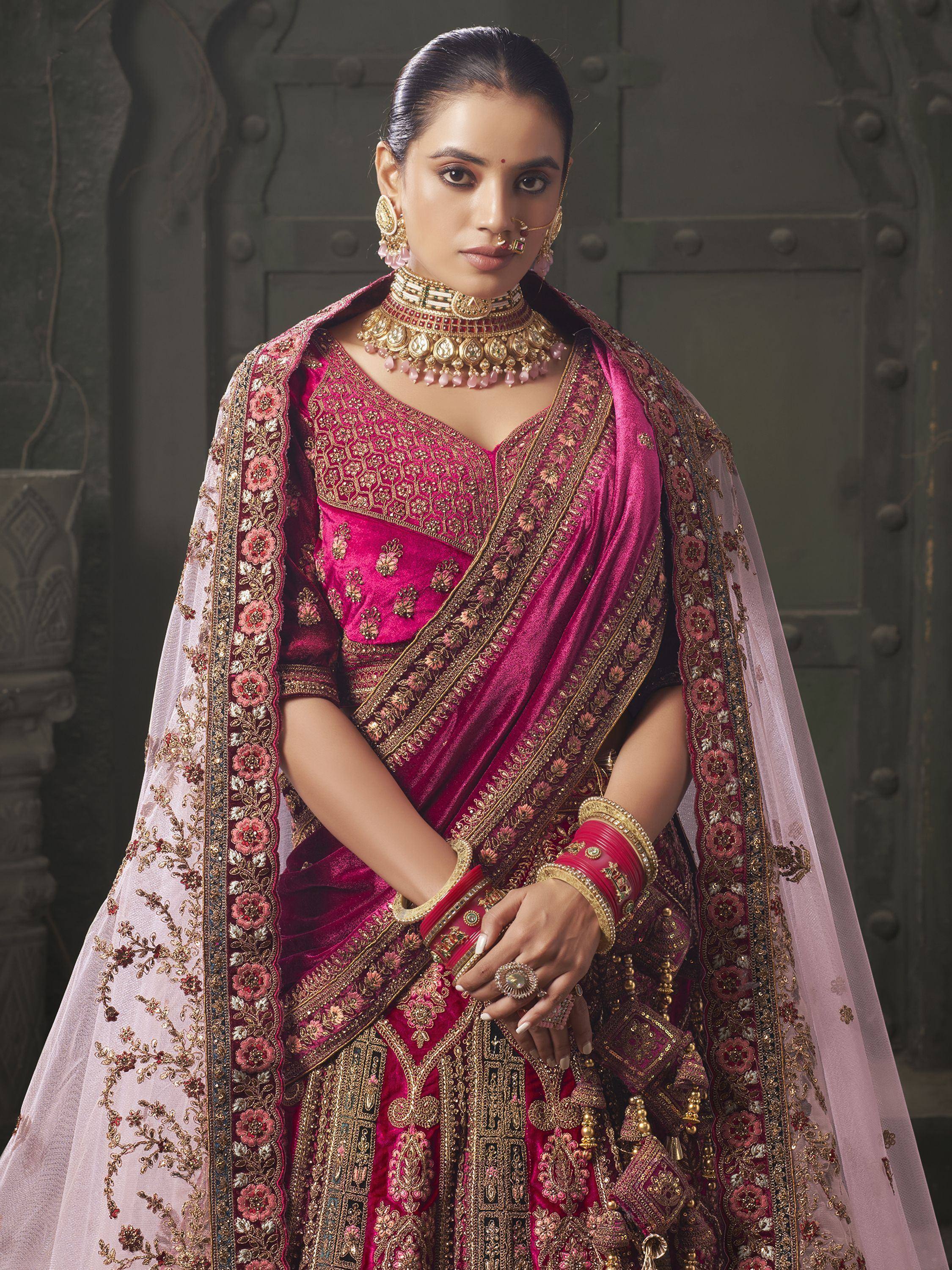 Elegant pink velvet lehenga choli with gold embroidery, perfect for Indian weddings and festive occasions.