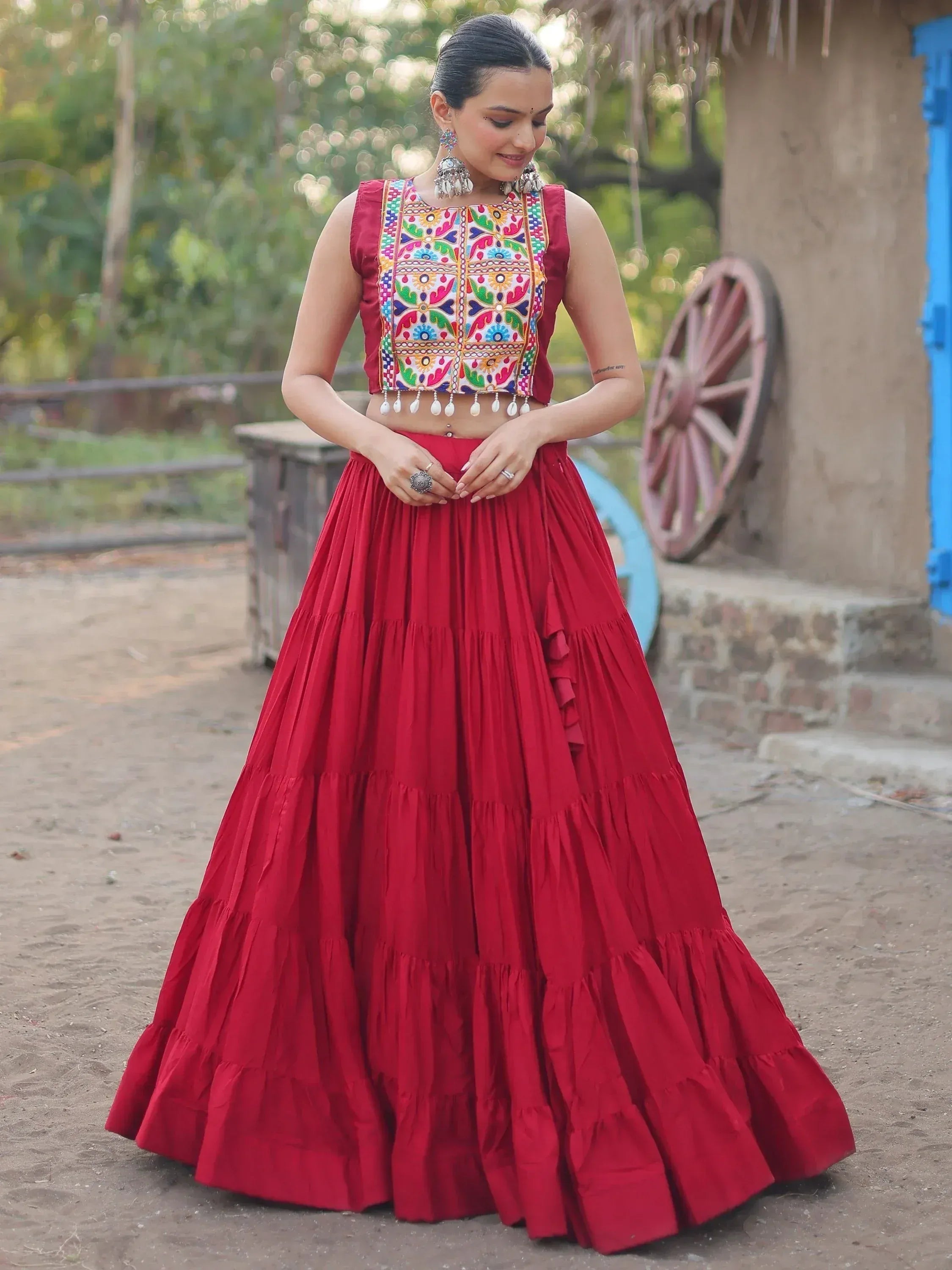 Red embroidered lehenga choli with colorful mirror work, perfect for Indian ethnic wear occasions