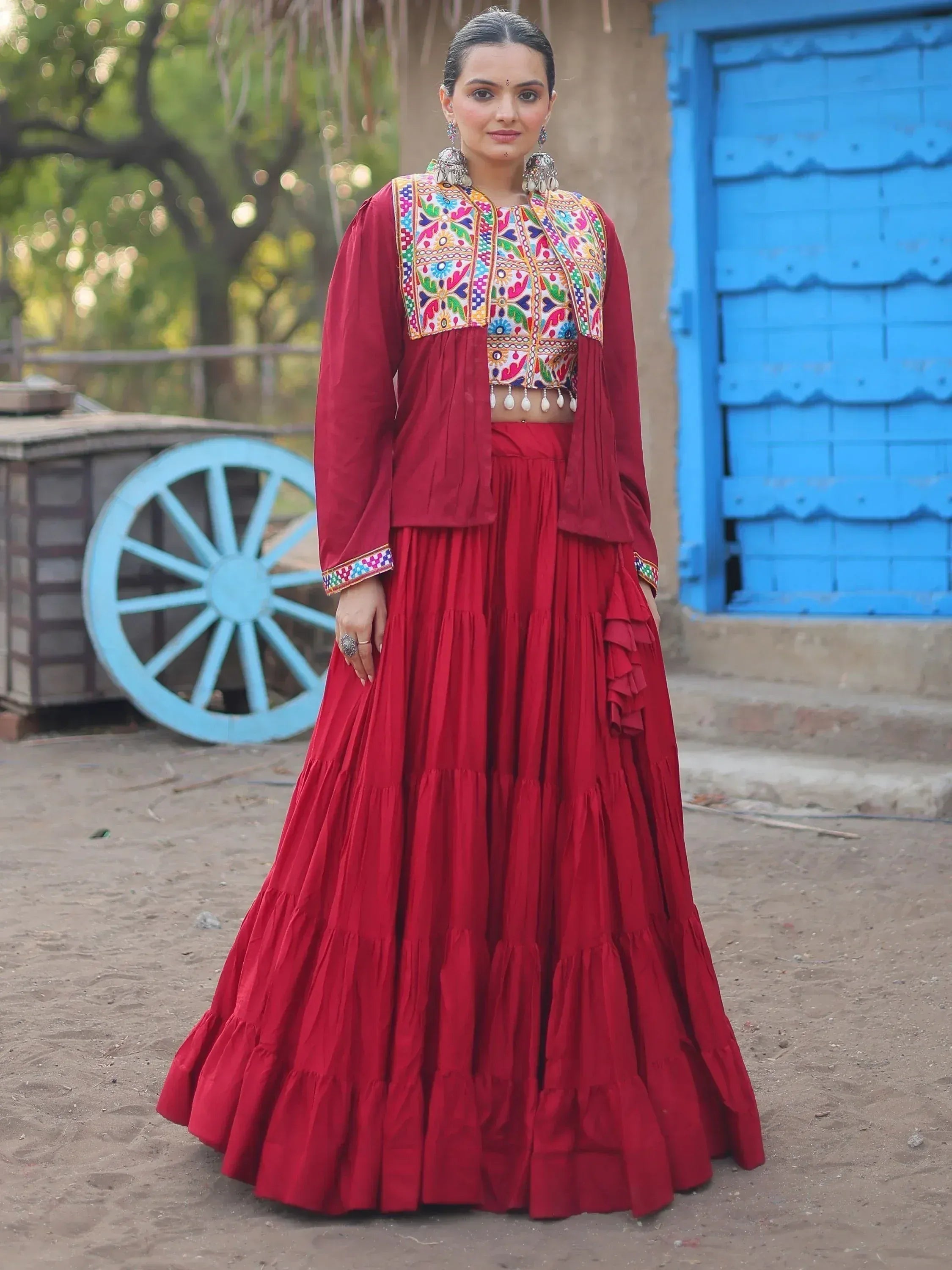 Red embroidered lehenga choli with colorful mirror work, perfect for Indian ethnic wear occasions