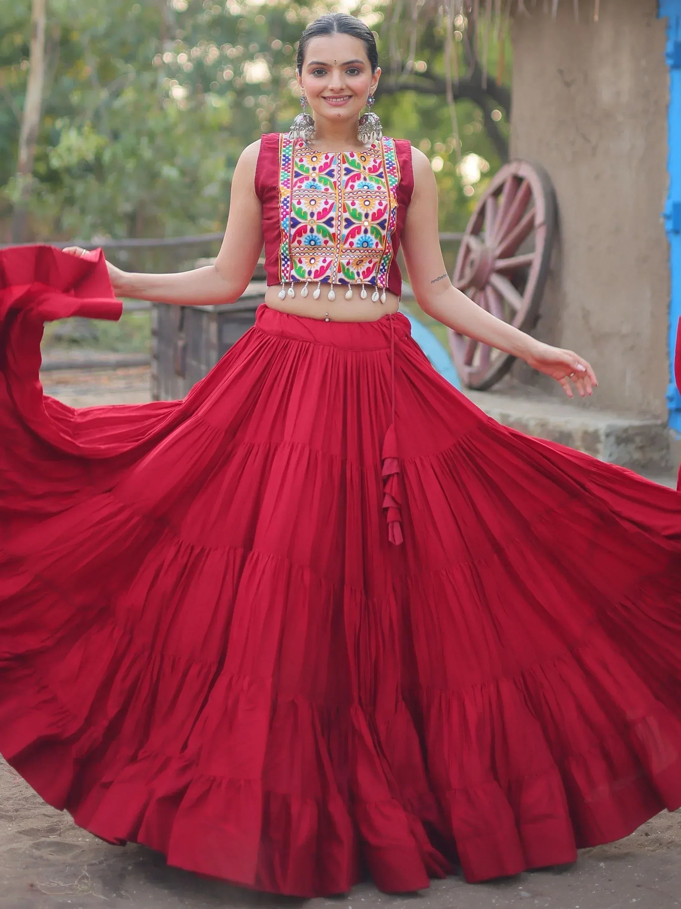 Red embroidered lehenga choli with colorful mirror work, perfect for Indian ethnic wear and festive occasions.