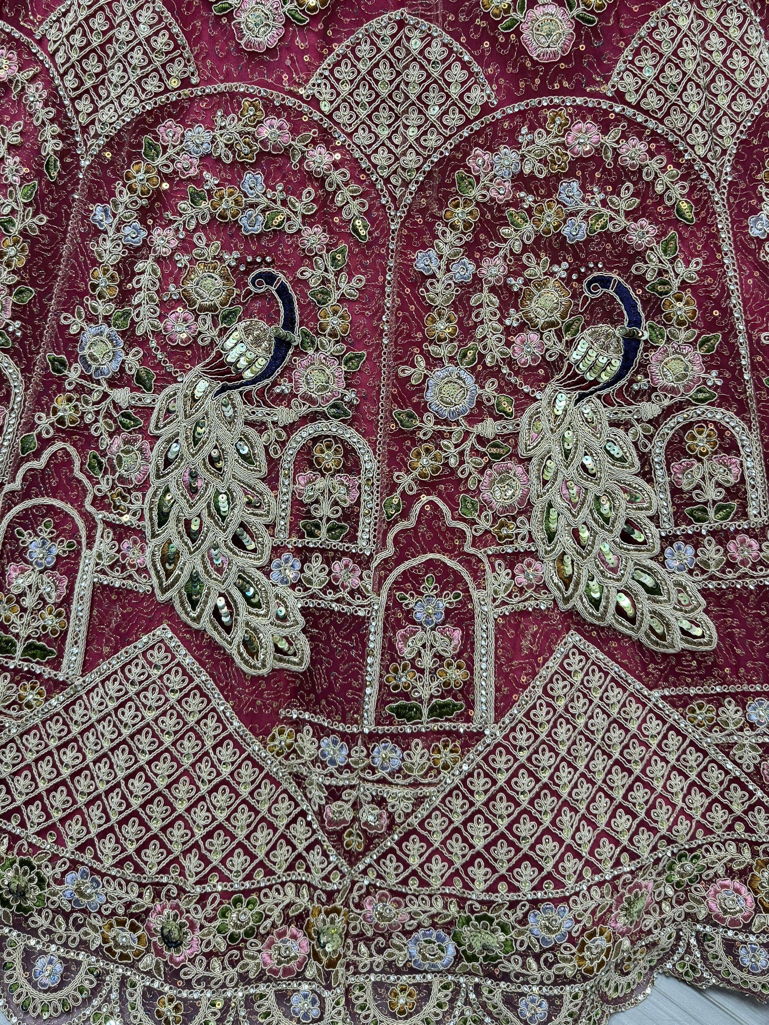 Luxury maroon lehenga choli with intricate peacock embroidery, floral motifs, and sequin detailing for Indian ethnic wear.