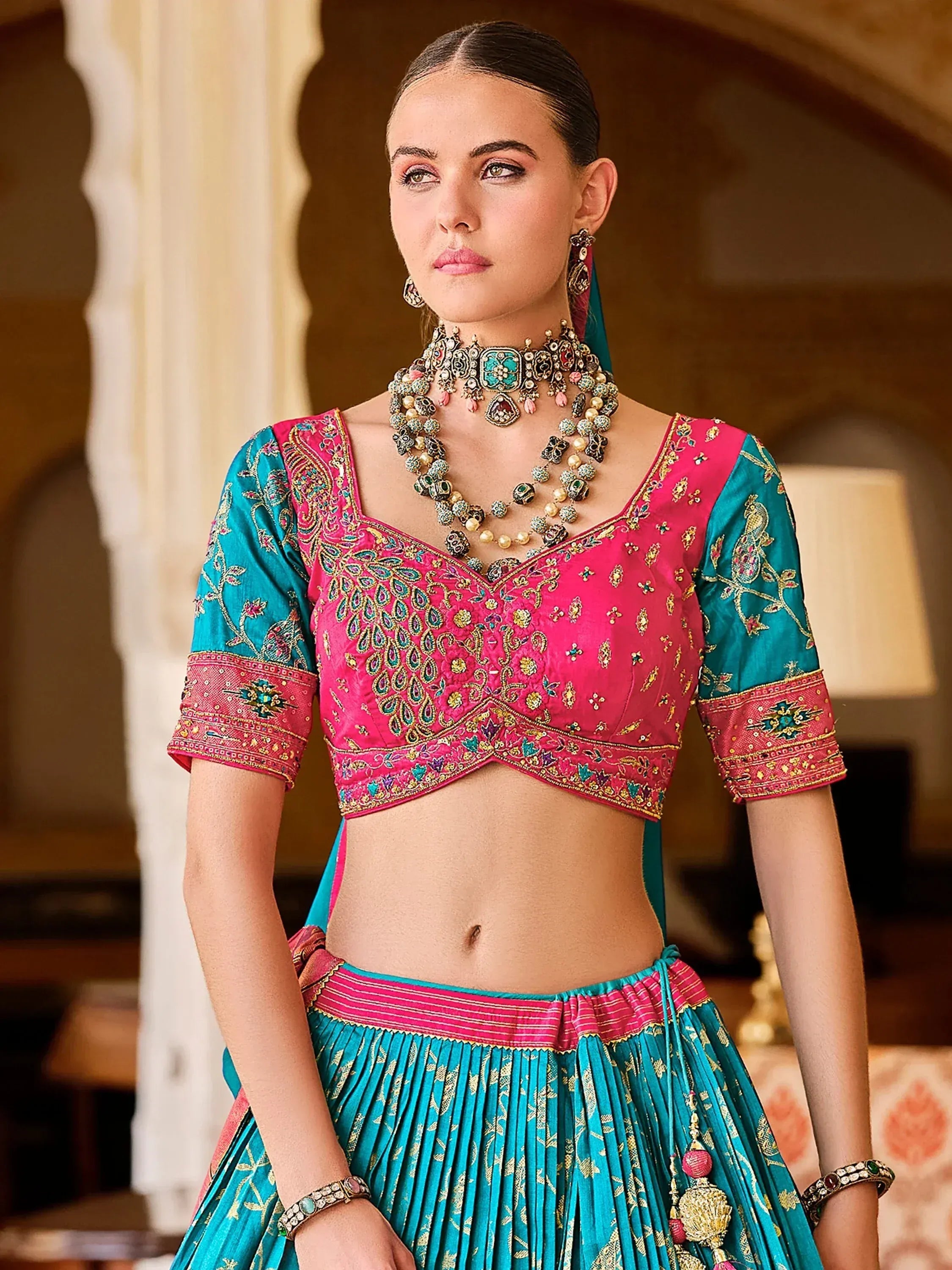 Pink and teal embroidered lehenga choli with heavy jewelry, Indian ethnic wear