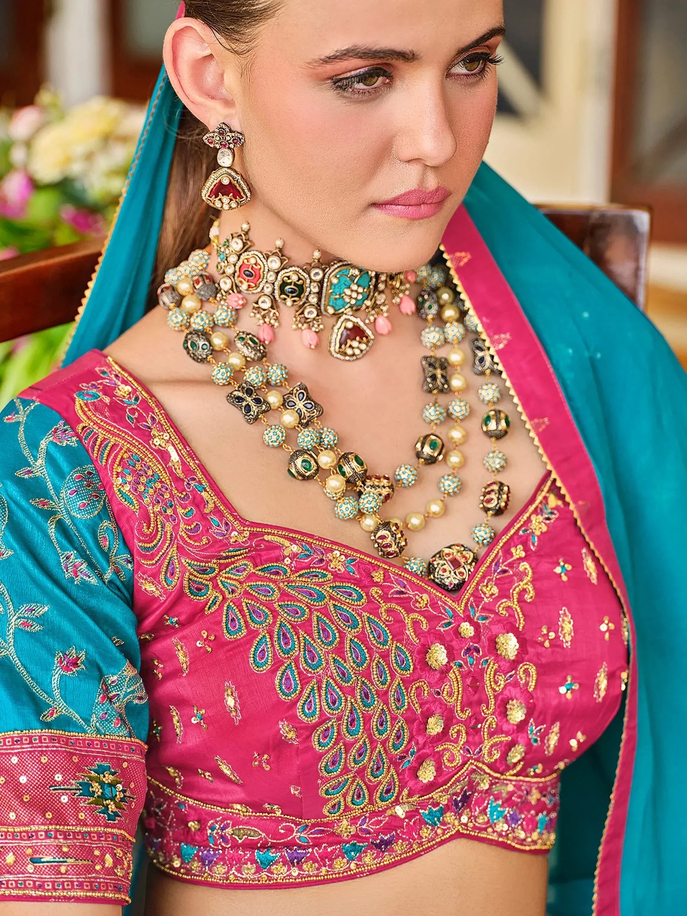 Pink and teal embroidered lehenga choli with heavy jewelry, Indian ethnic wear