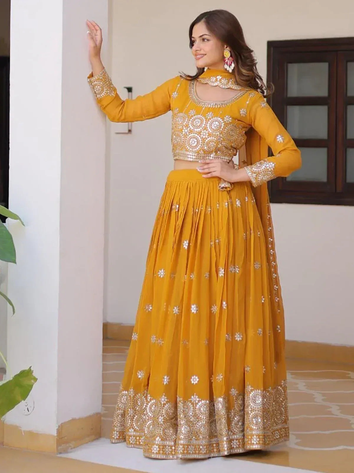 Yellow embroidered lehenga choli with mirror work, perfect for Indian ethnic wear occasions