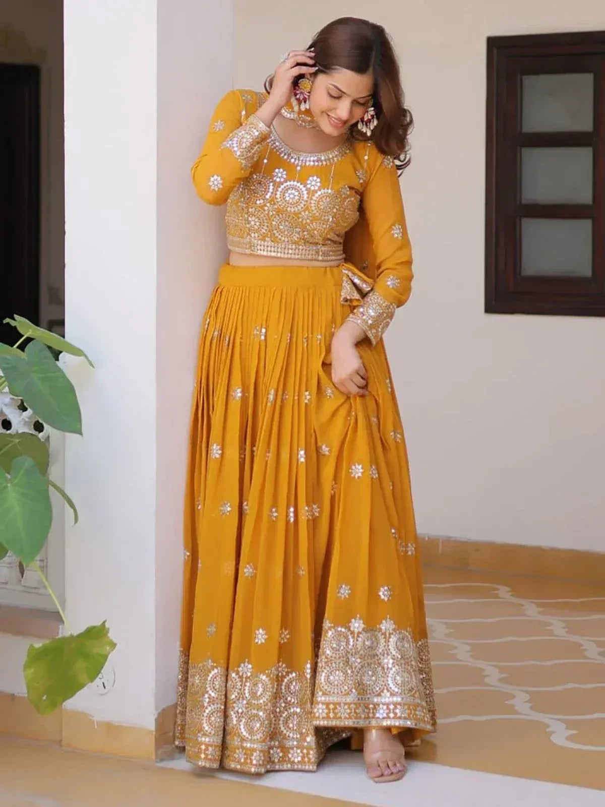 Yellow embroidered lehenga choli with mirror work, perfect for Indian ethnic wear and festive occasions
