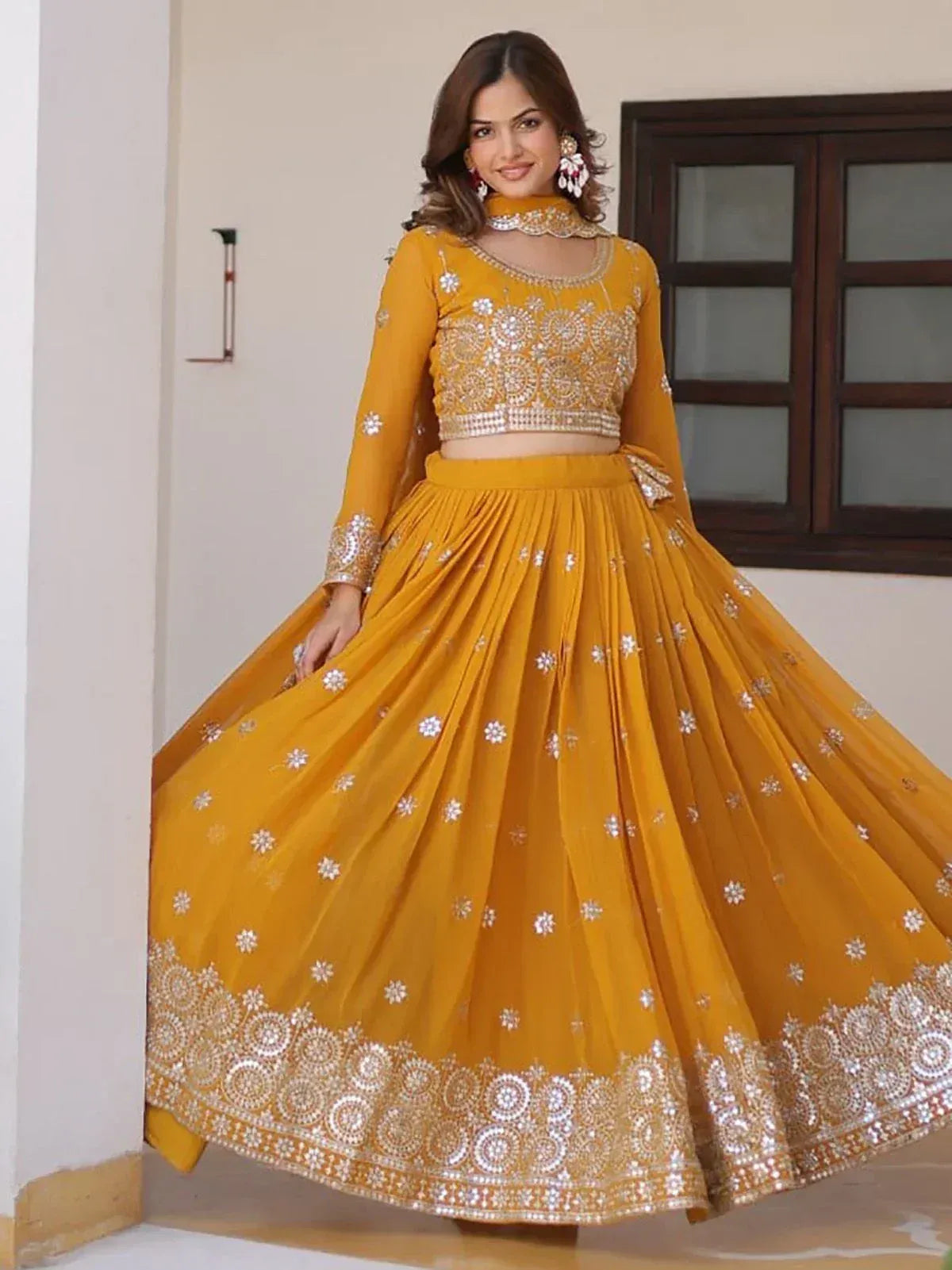 Mustard yellow designer lehenga choli with floral embroidery and mirror work, perfect for Indian ethnic occasions