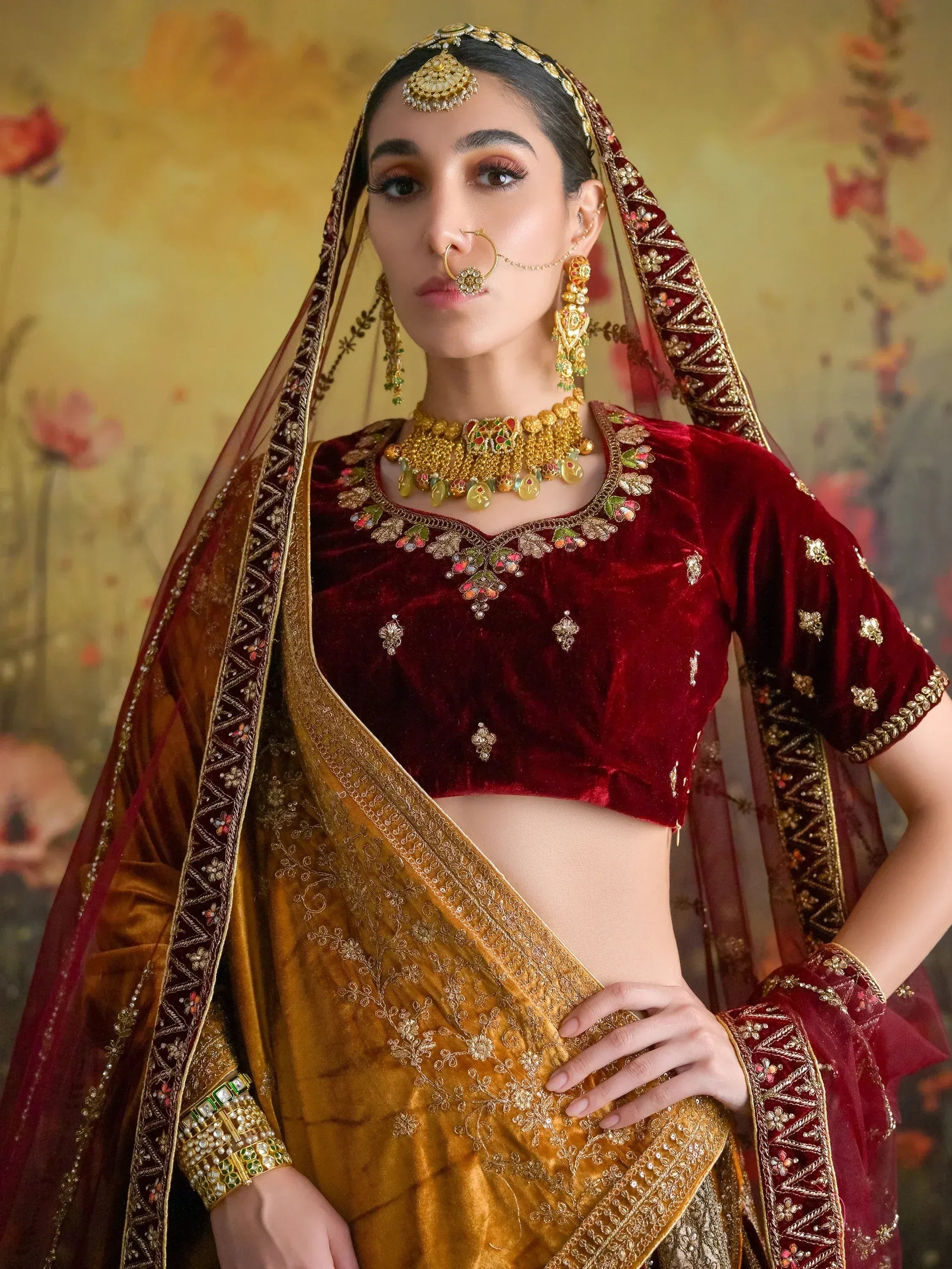 Maroon velvet lehenga choli with gold embroidery, traditional Indian bridal wear, heavy jewelry