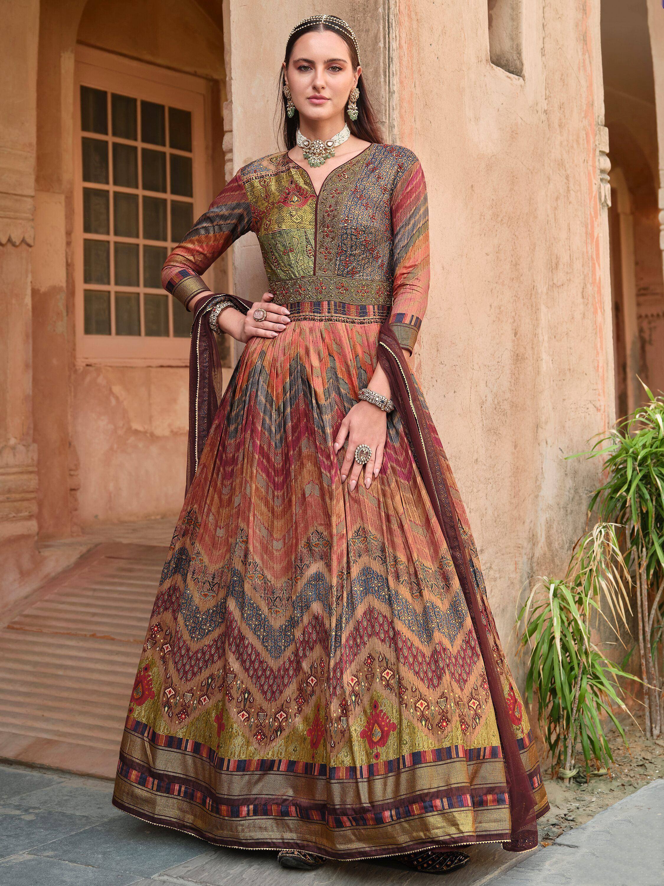 Woman in designer ethnic anarkali gown with intricate patterns, perfect for Indian occasions and weddings.