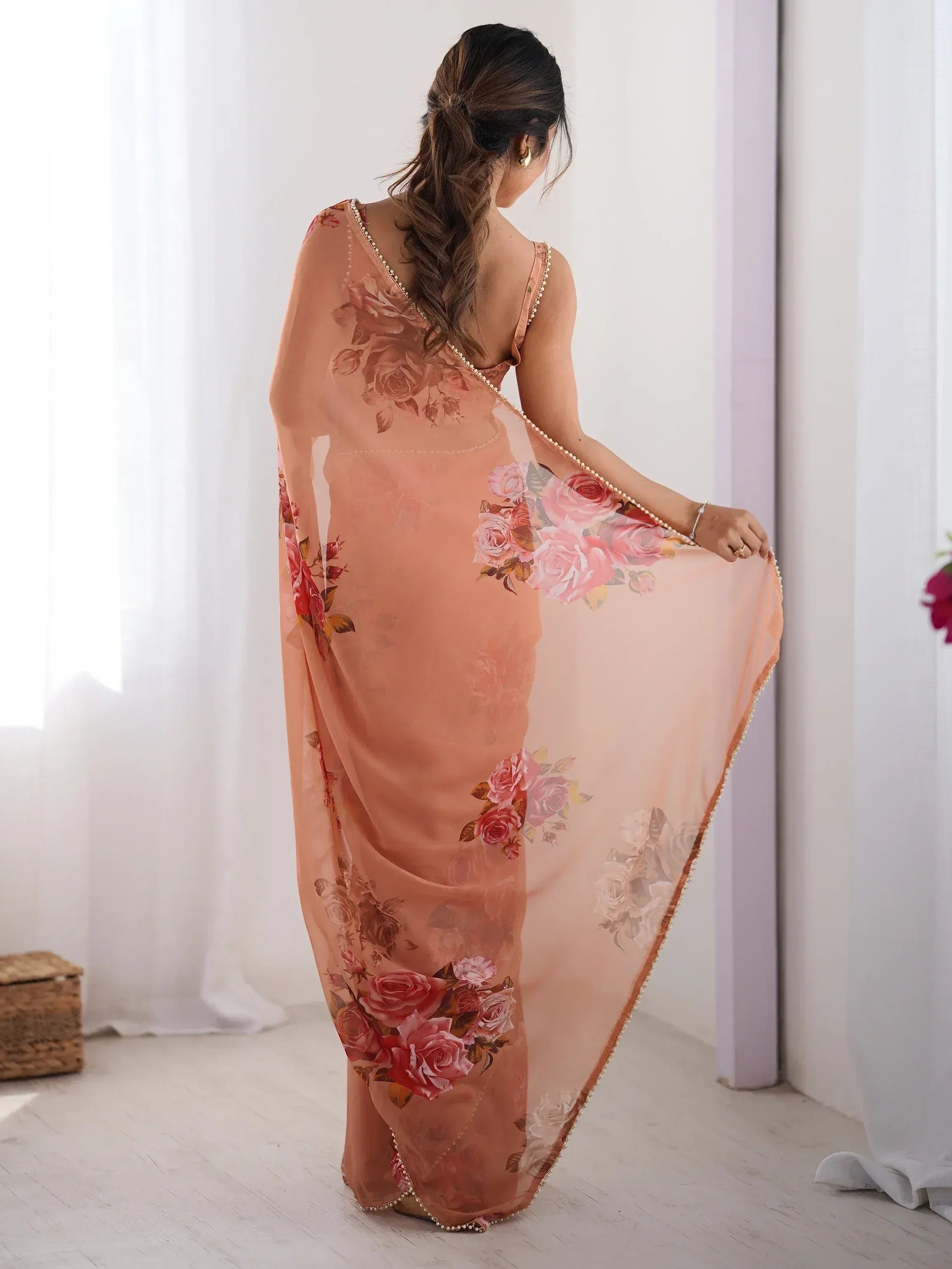 Peach floral saree with pearl border, elegant Indian ethnic wear for women