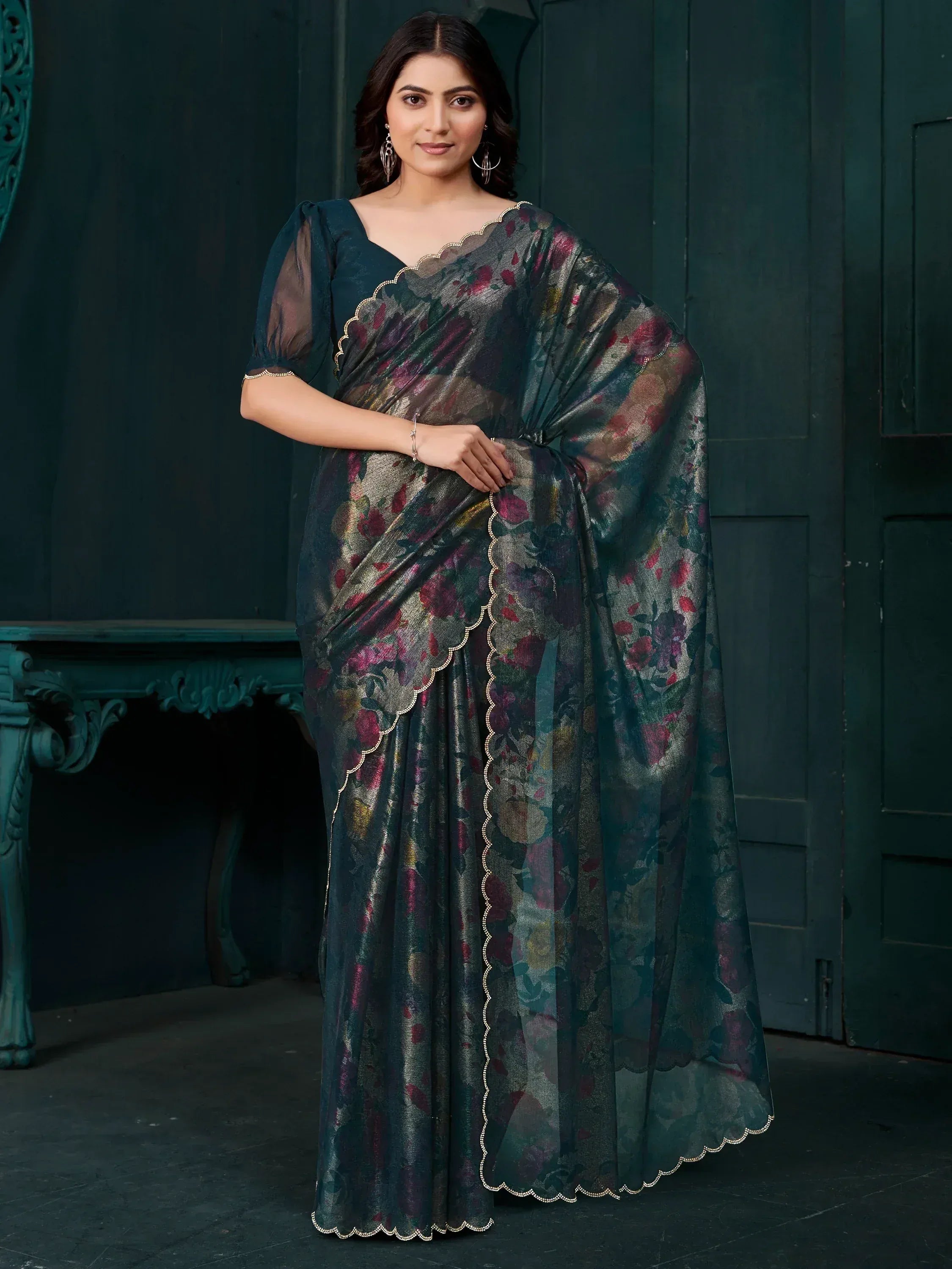 Elegant dark green floral saree with scalloped gold trim, paired with sheer puff sleeves for ethnic wear