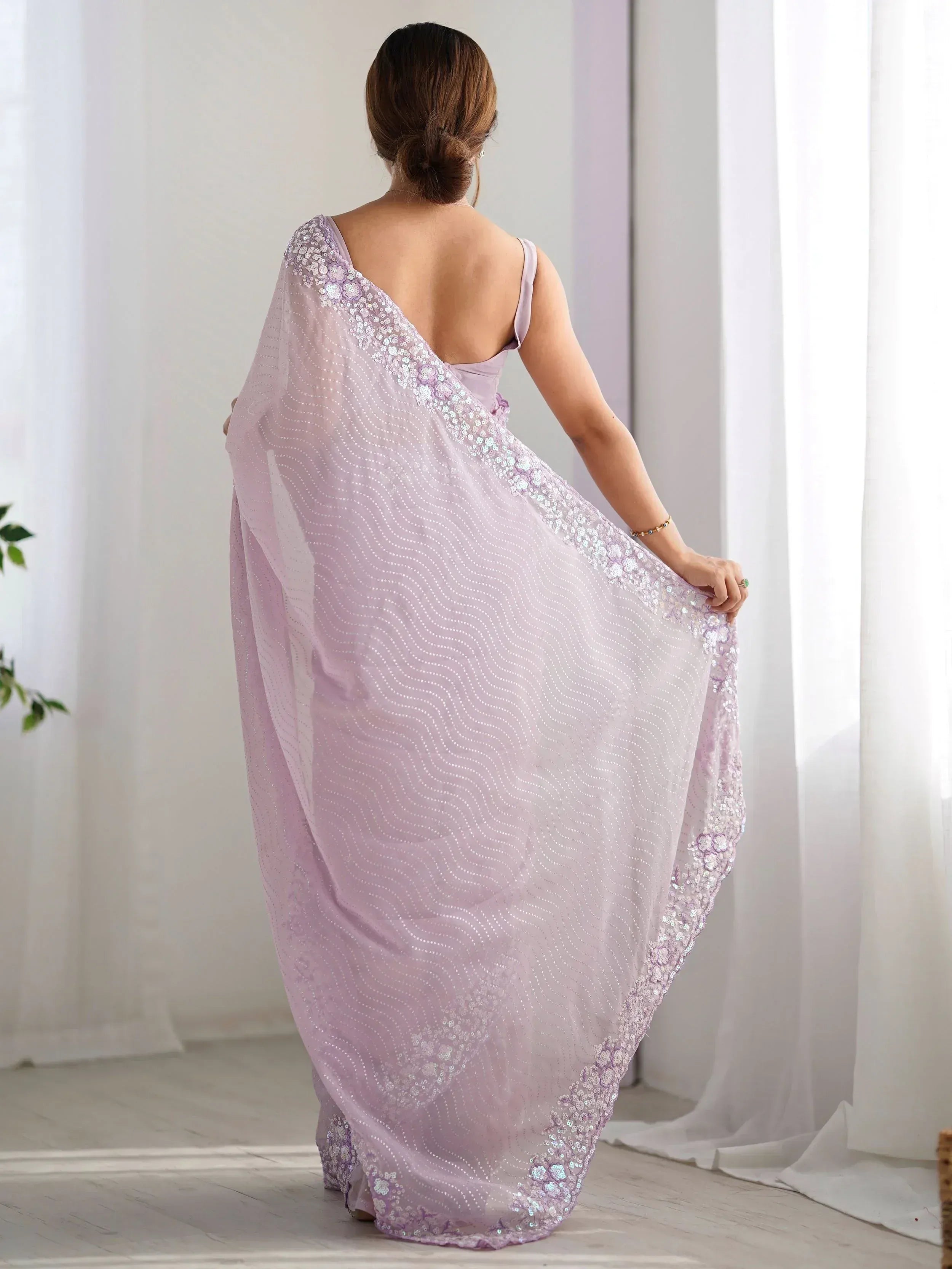 Lavender ethnic saree with sequin floral border, back view, perfect for Indian weddings or parties