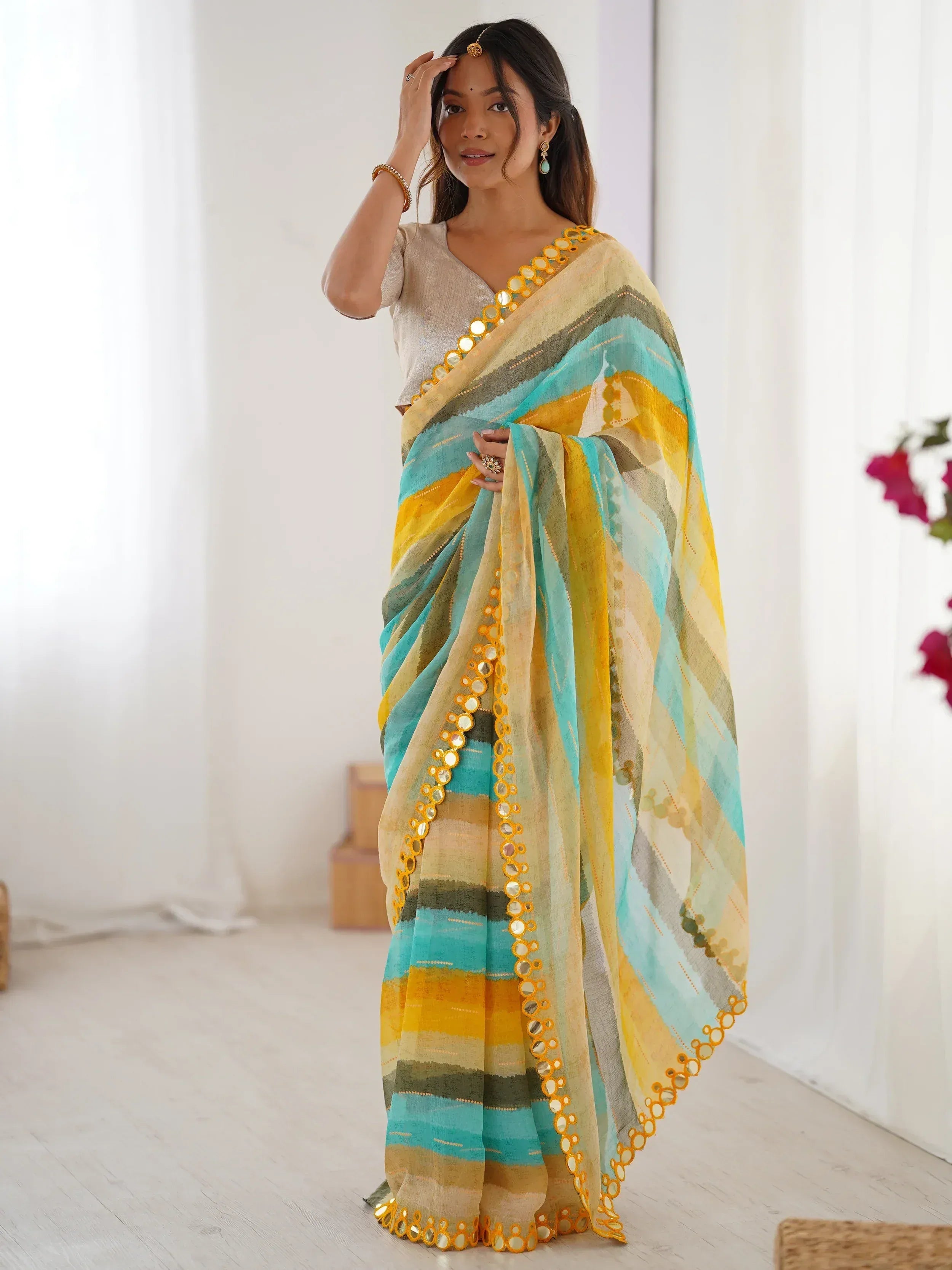 Woman in colorful striped saree with mirror work, ethnic Indian wear