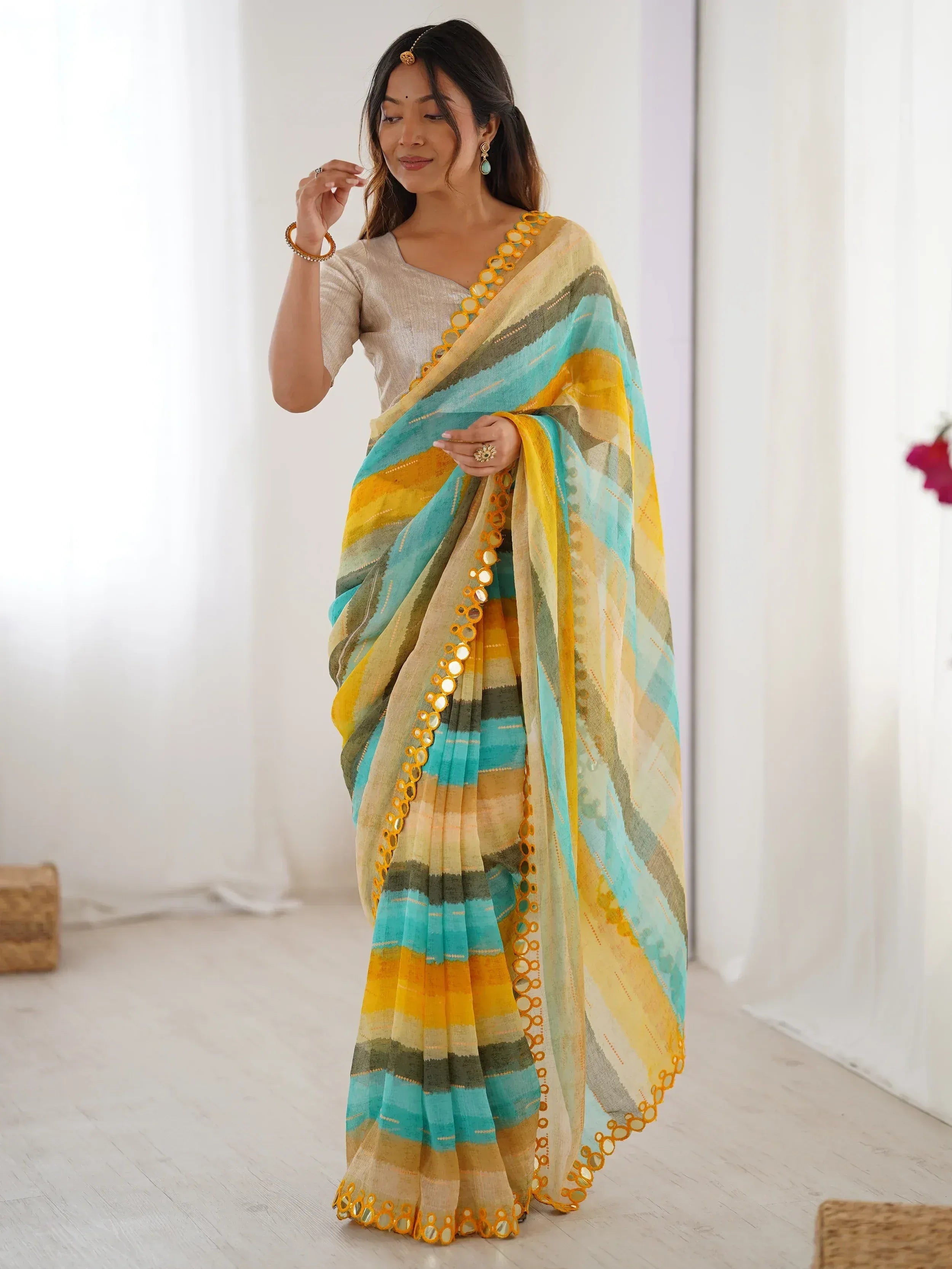 Woman in colorful striped saree with mirror work, ethnic Indian wear for festive occasions