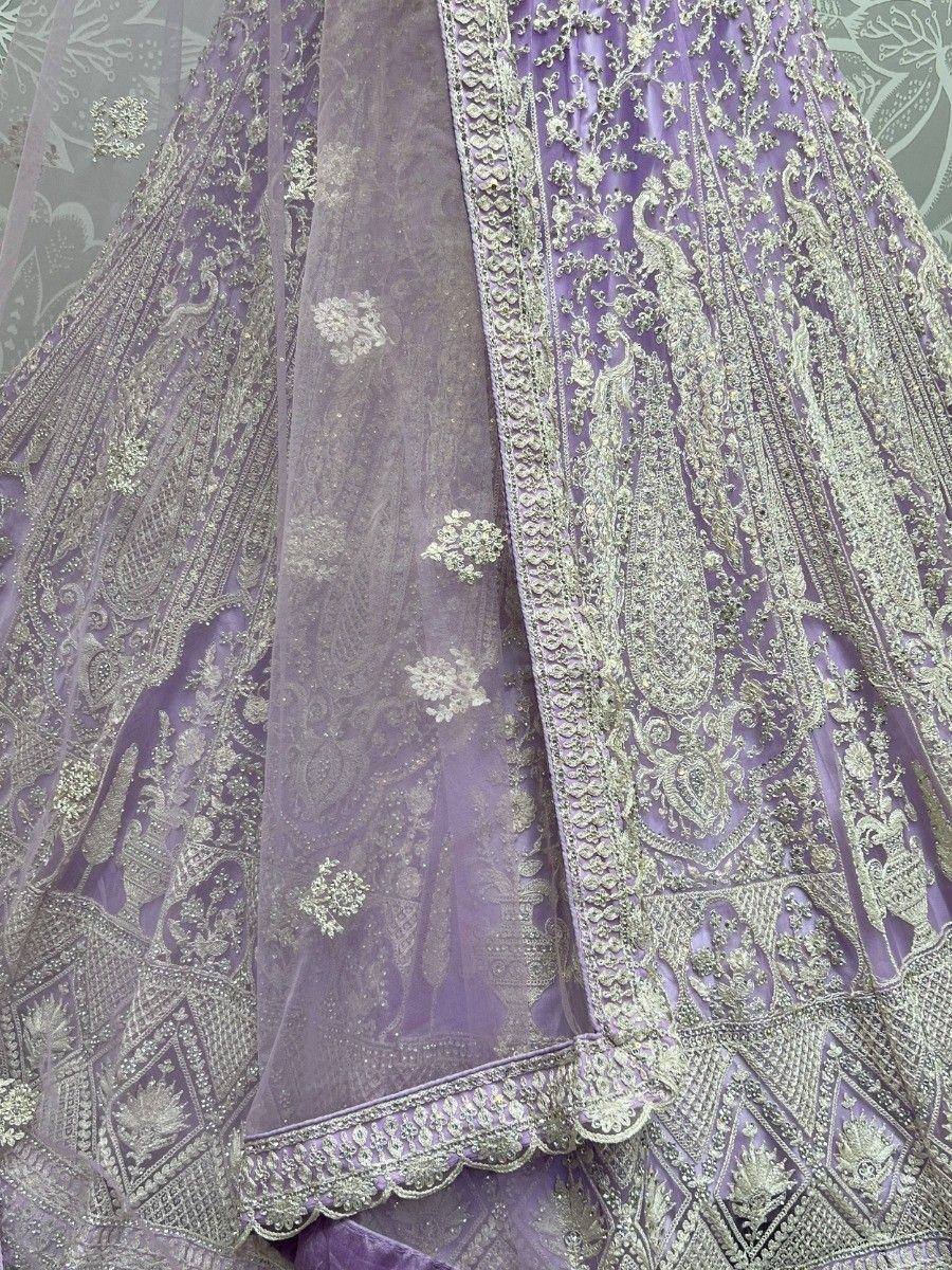 Lavender designer lehenga choli with intricate gold embroidery and sheer dupatta, perfect for Indian ethnic wear.