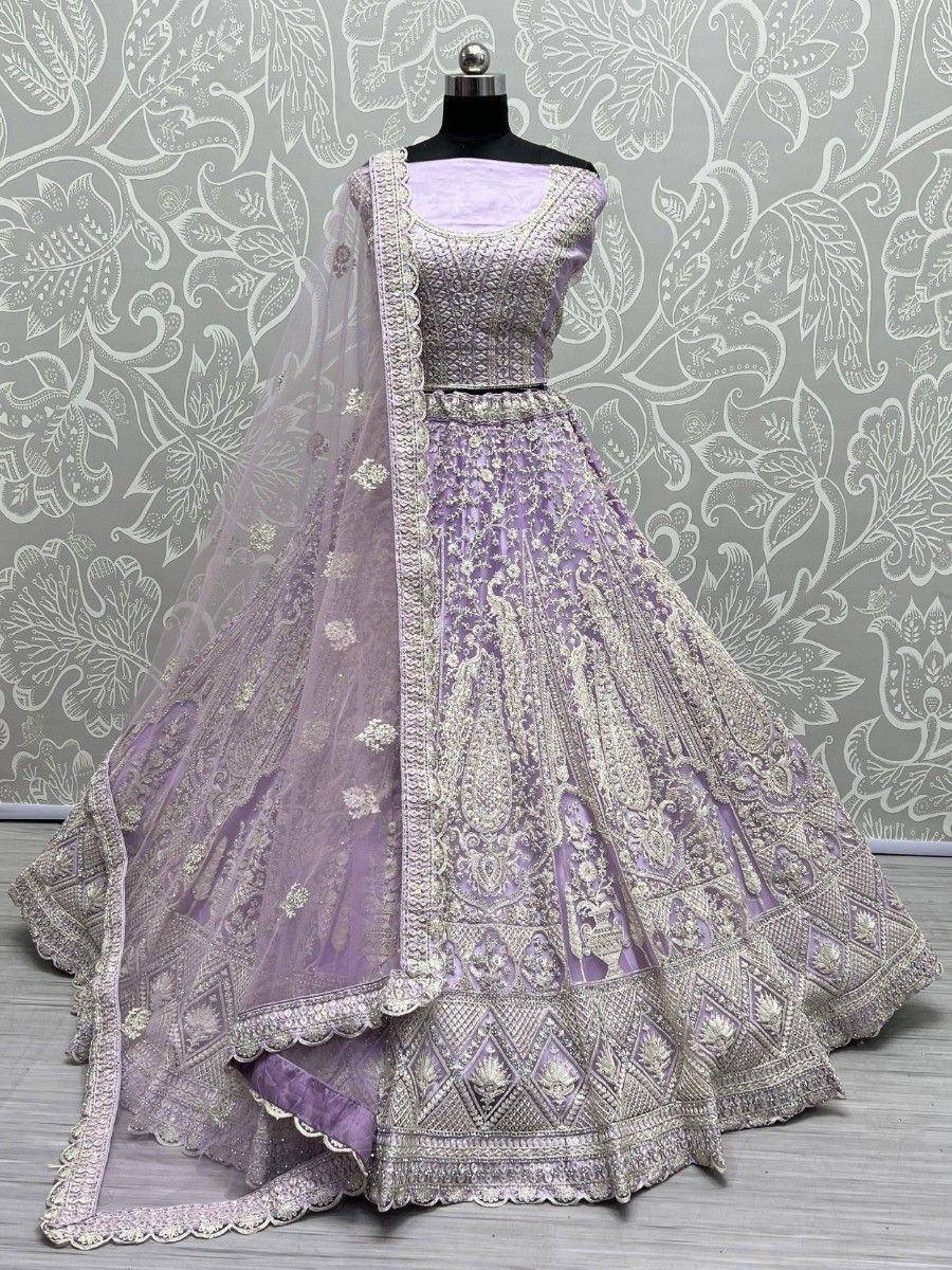 Lavender designer lehenga choli with heavy embroidery and matching dupatta, ideal for weddings and festive occasions.