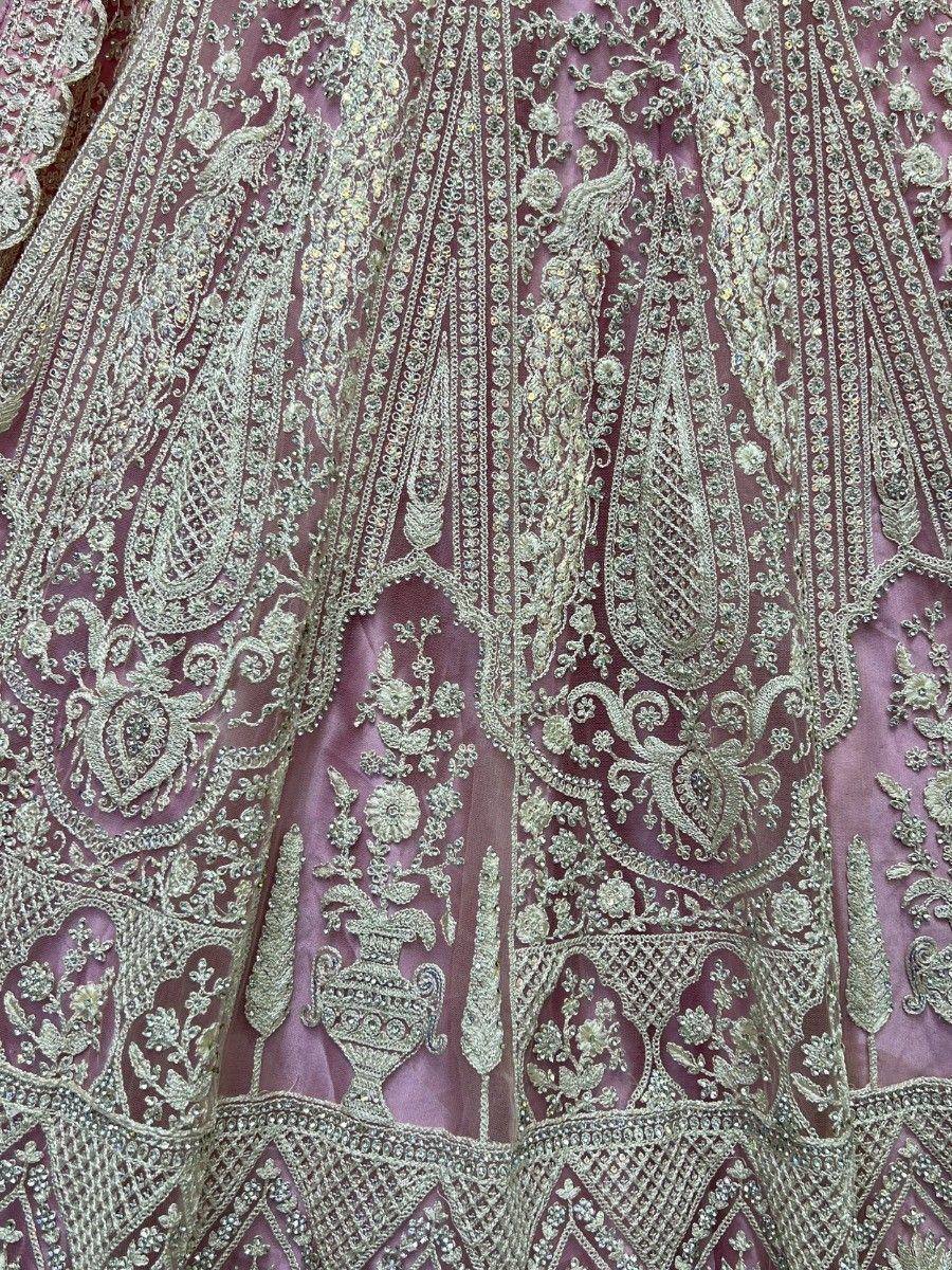 Luxury Indian lehenga with intricate gold embroidery and floral motifs on maroon fabric